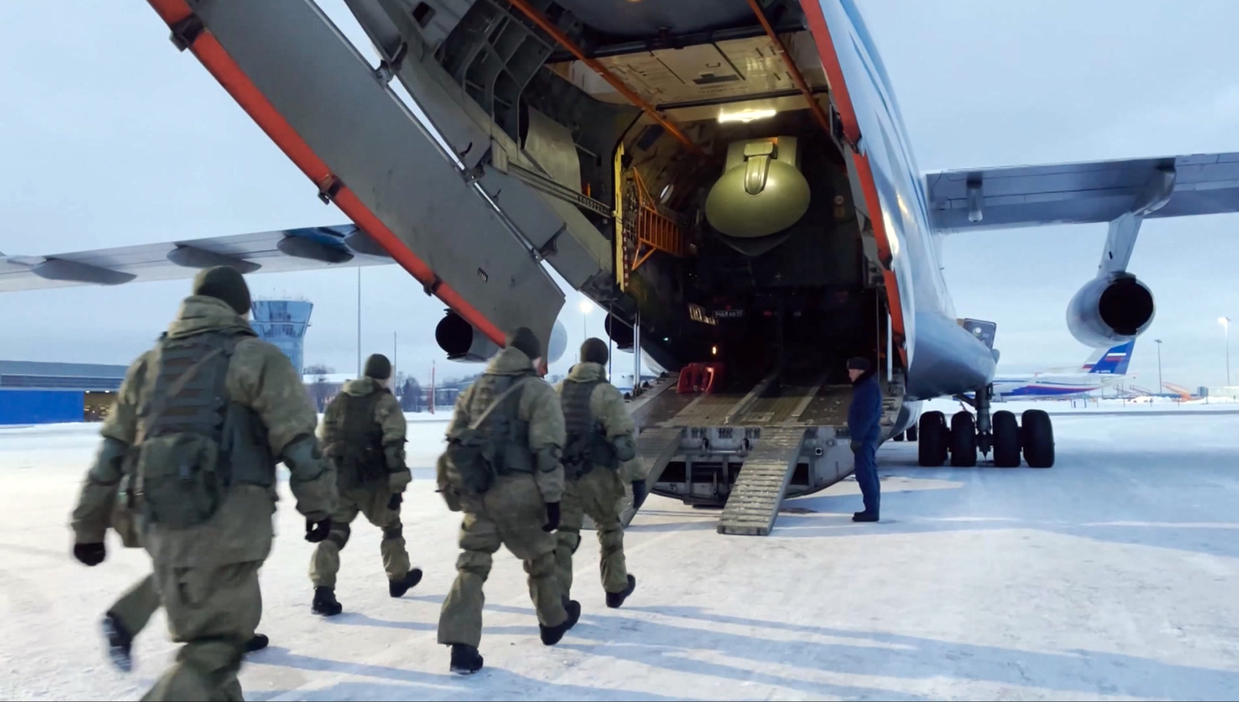 Russian peacekeepers board a Russian military plane at an airfield outside Moscow, Russia, to fly to Kazakhstan