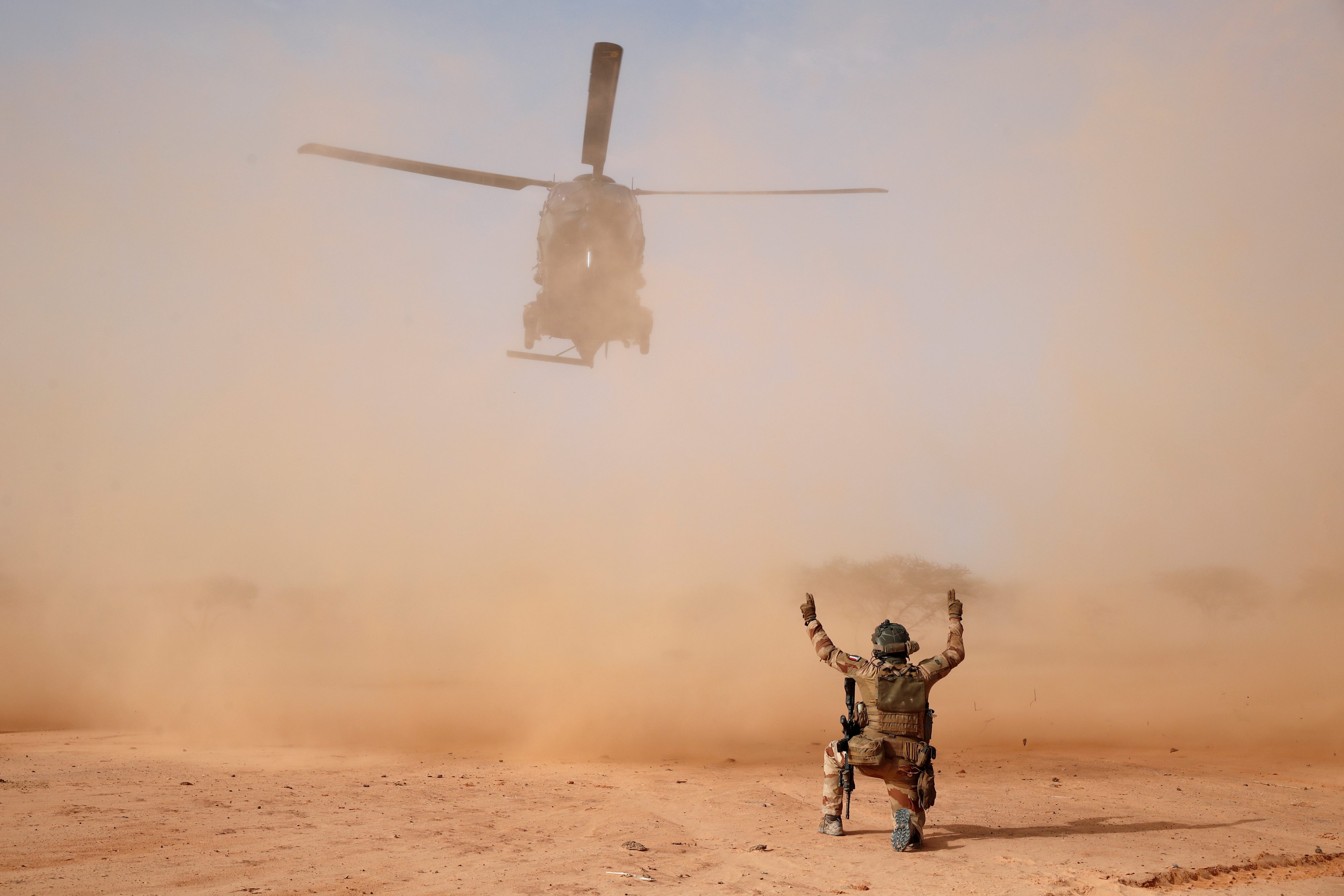 An NH90 Caiman military helicopter lands next to a temporary forward operating base (TFOB) during Operation Barkhane in Ndaki, Mali