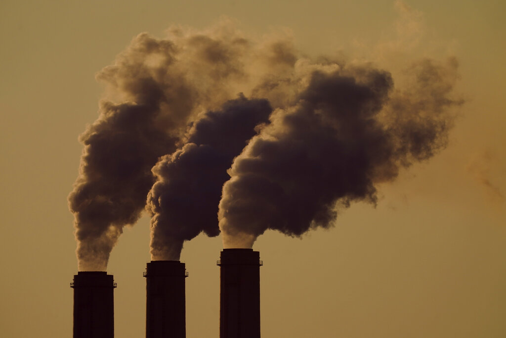 Emissions rise from the smokestacks at the Jeffrey Energy Center coal power plant as the suns sets, near Emmett, Kansas.