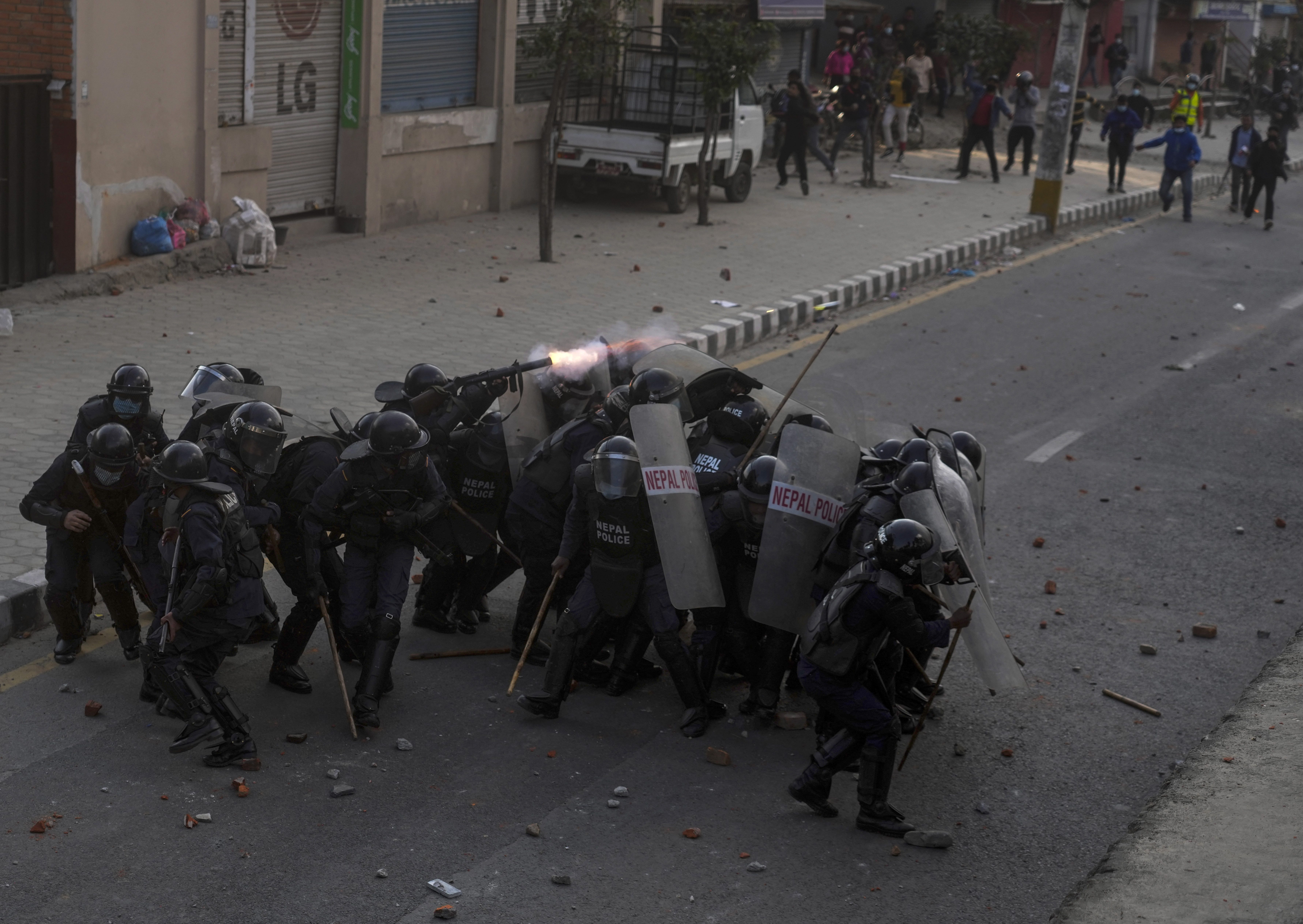 Nepalese policemen take cover