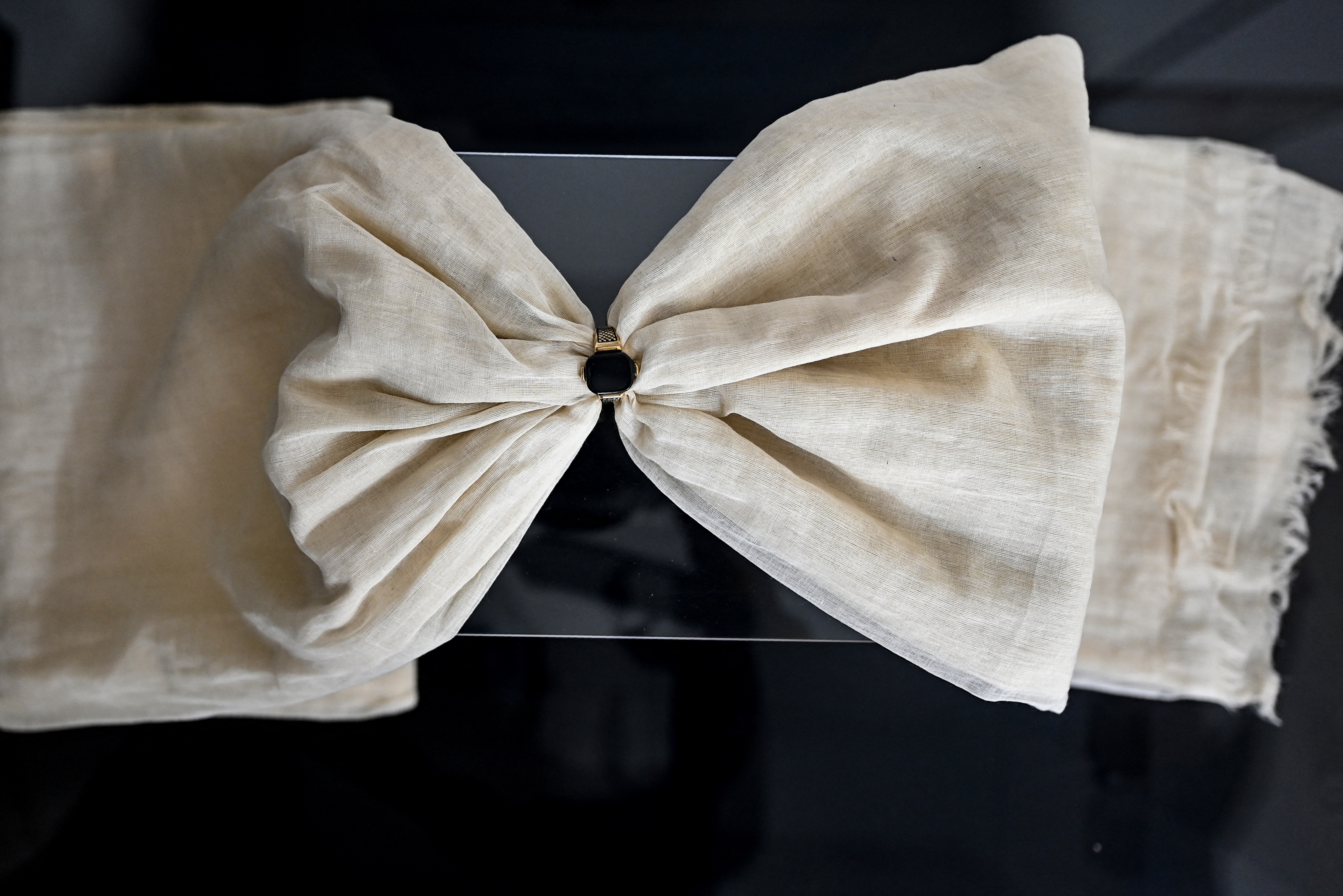 A newly-woven fine muslin sari moved through a ring to display the quality of the clothing at a display centre in Dhaka