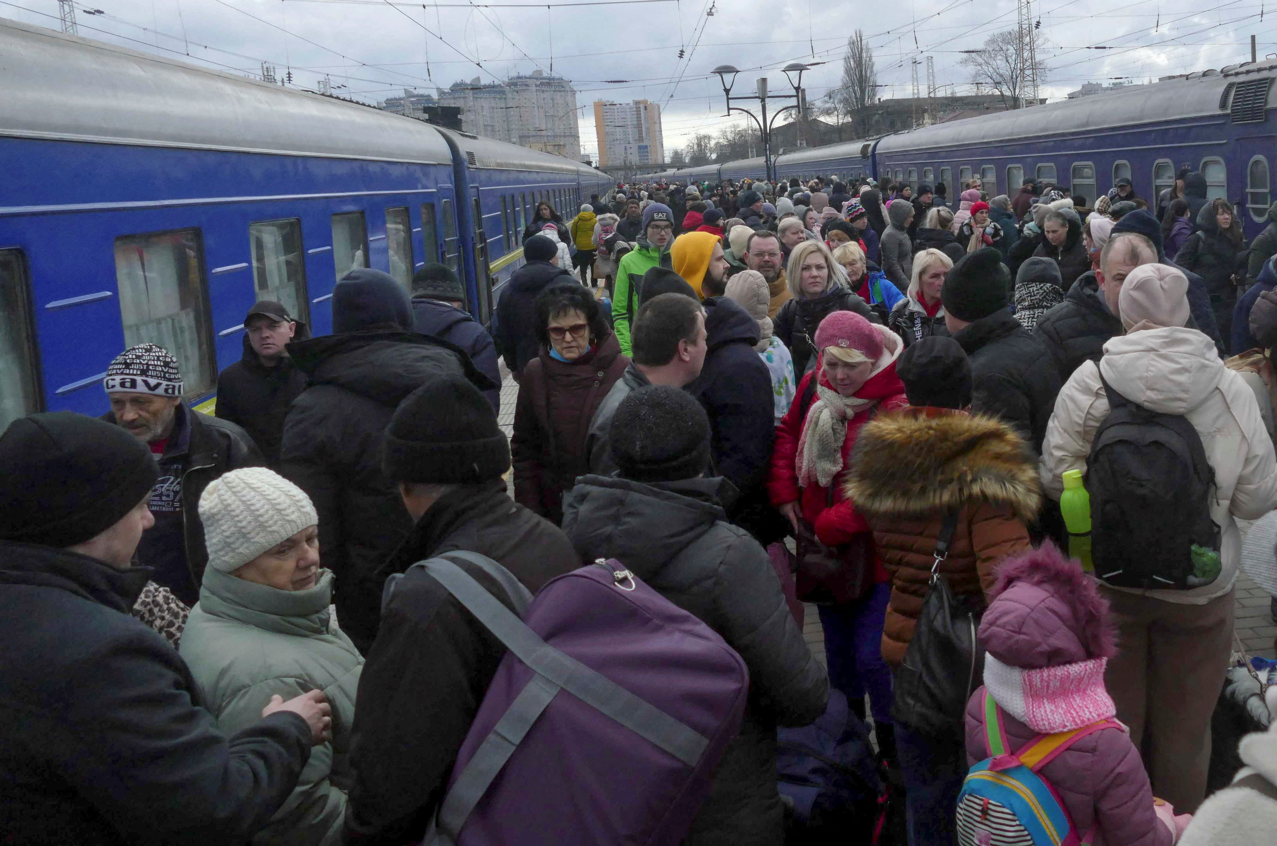 People fleeing Russia’s invasion of Ukraine crowd on a platform to board a train as they leave the city of Odesa on March 4, 2022