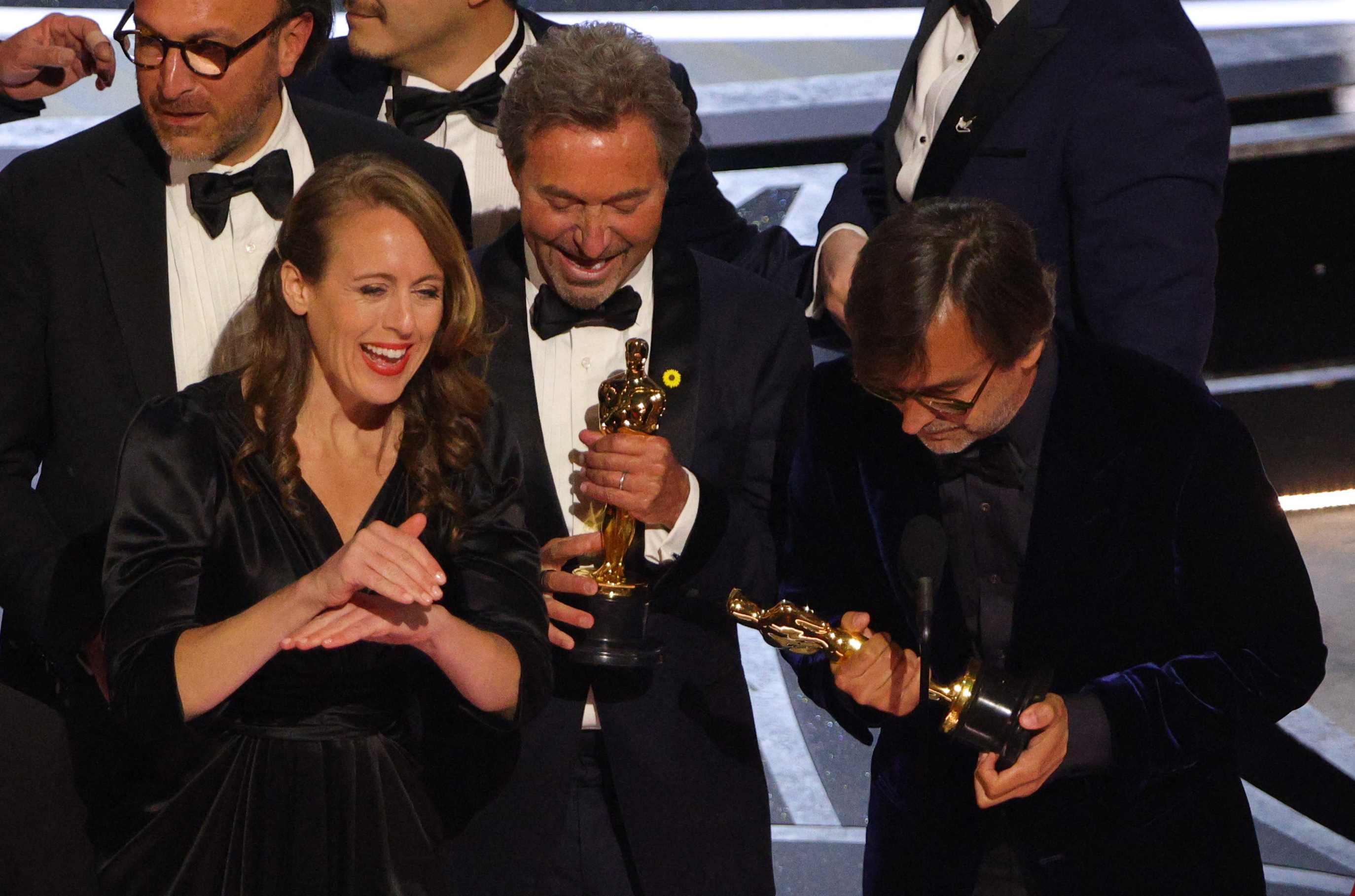 Philippe Rousselet, Fabrice Gianfermi and Patrick Wachsberger celebrate after winning the Oscar for Best Picture for "CODA" at the 94th Academy Awards in Hollywood, Los Angeles