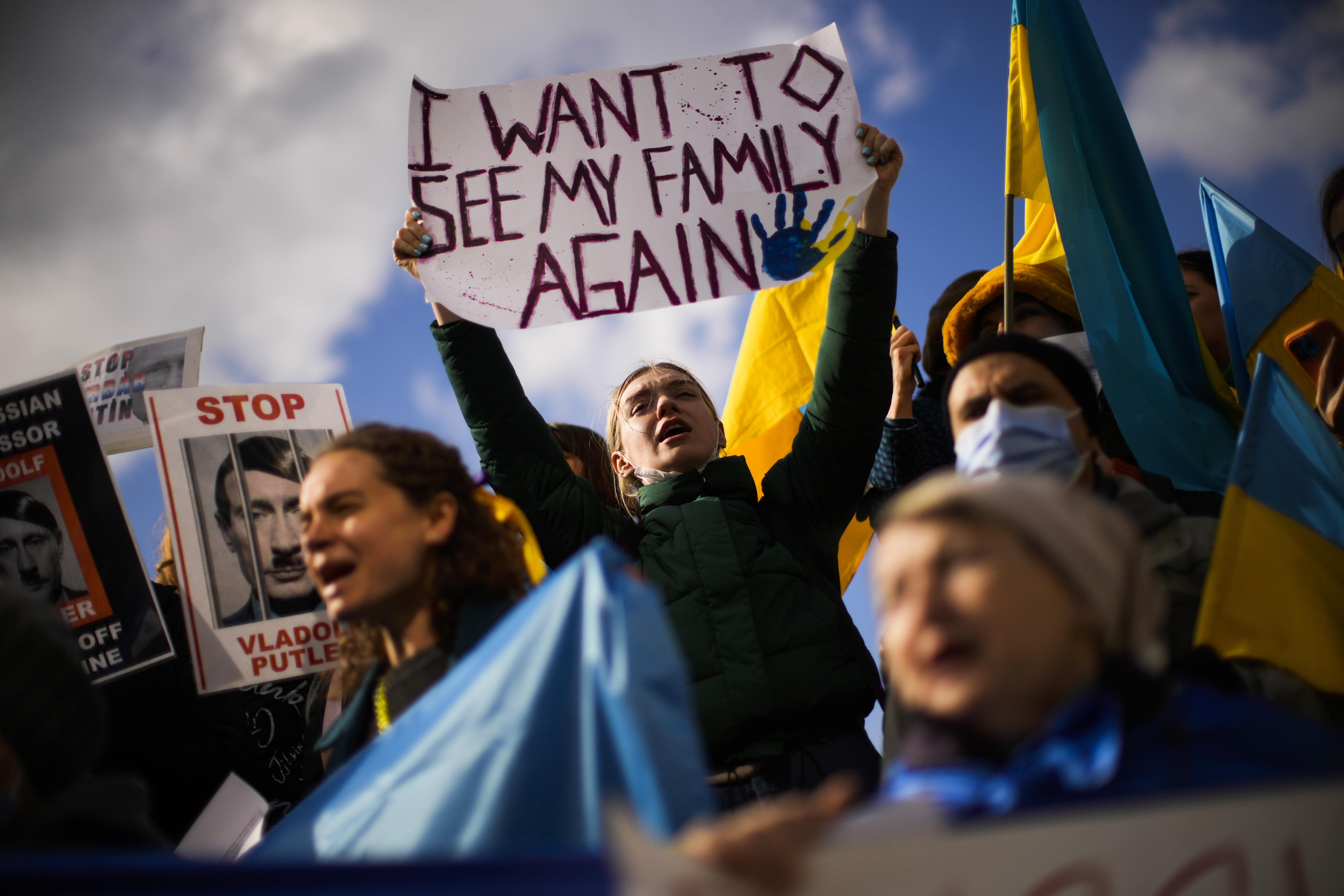 Pro-Ukrainian people hold up placards and wave Ukrainian flags as they shout slogans during a protest against Russia's invasion of Ukraine, in Istanbul