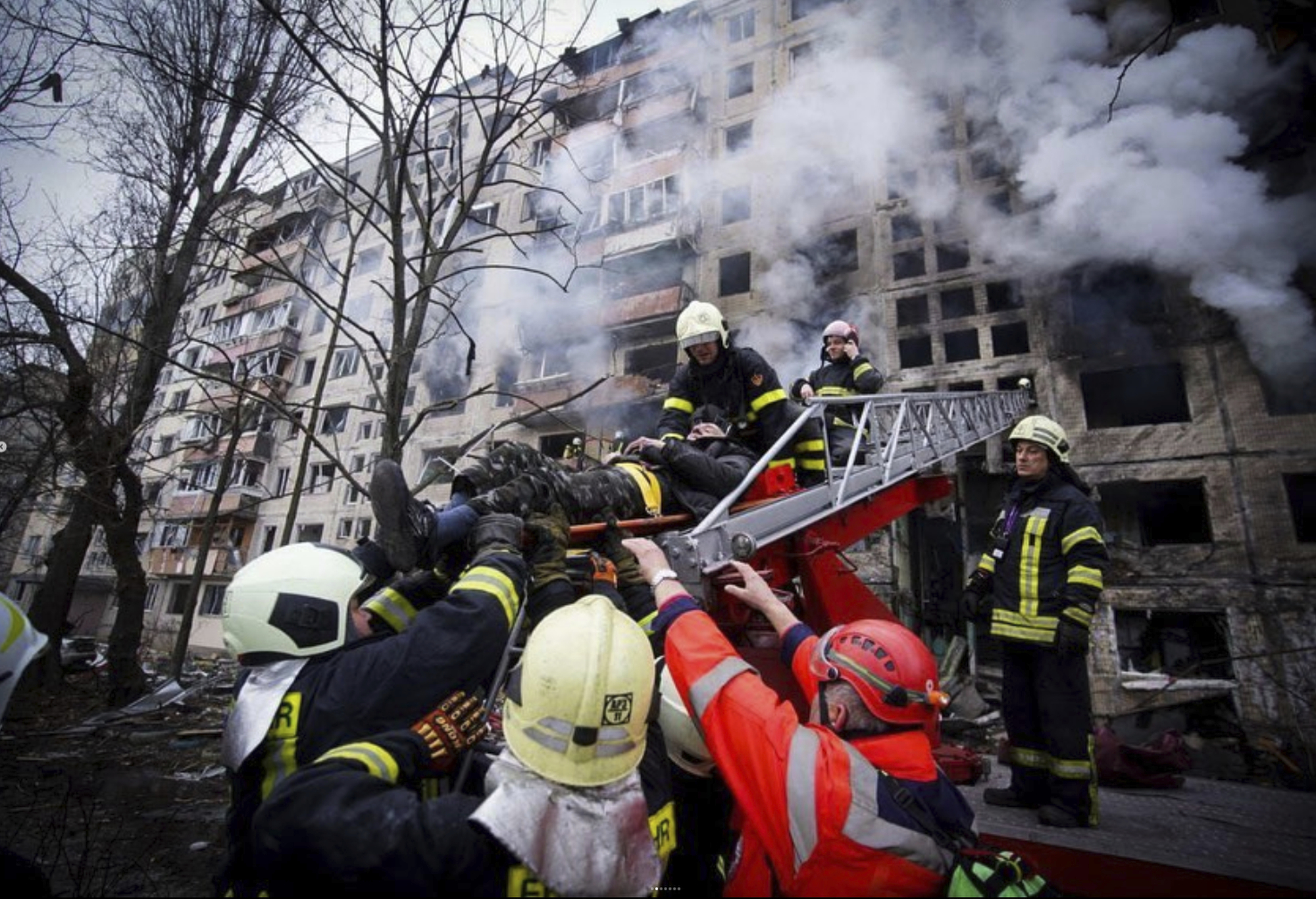 FFirefighters evacuate a man from an apartment building