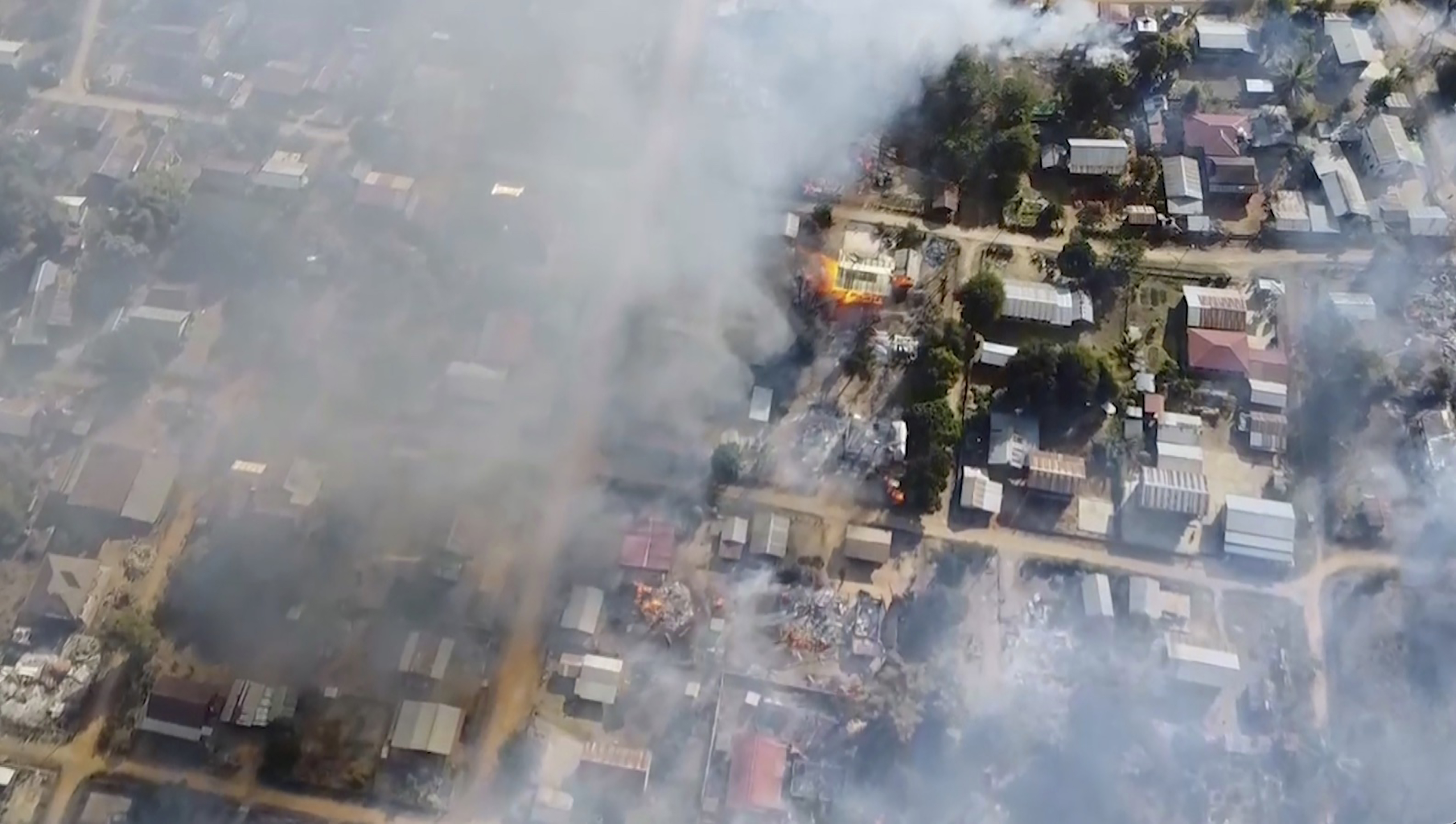 smoke arises from burning buildings in Waraisuplia village in Kayah State following a military attack in February