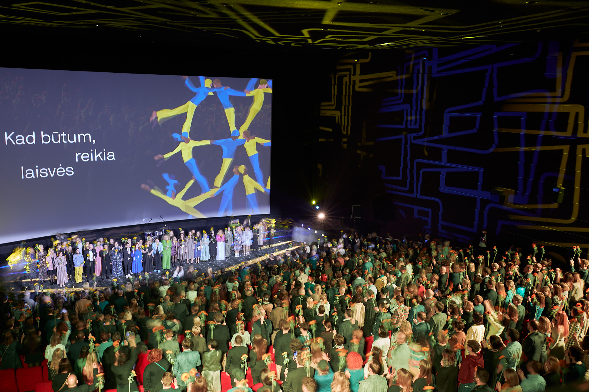 Screen with festival logo in front of audience
