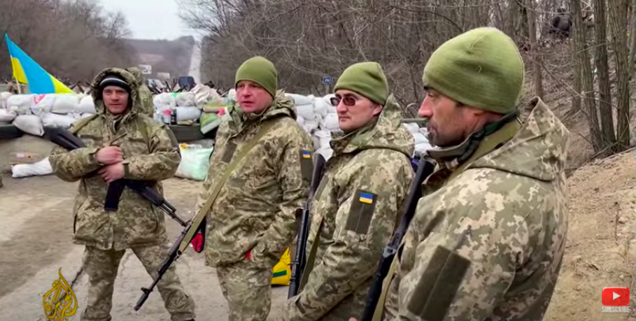 A screen shot of a video shows Ukrainian civilian volunteers armed and dressed in camouflage