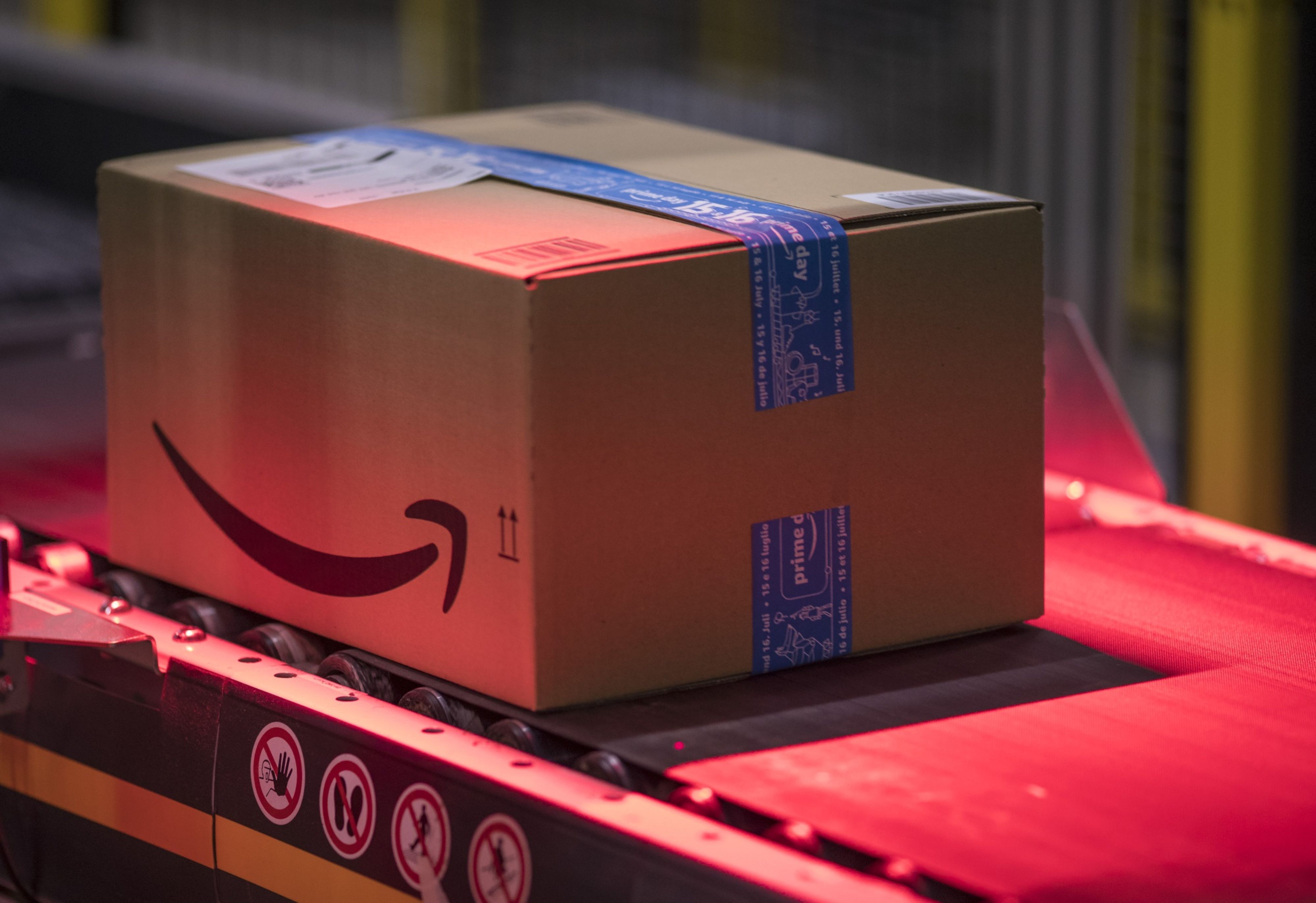 Packed boxes pass along a conveyor belt at the Amazon.com Inc. fulfilment centre in Tilbury, UK