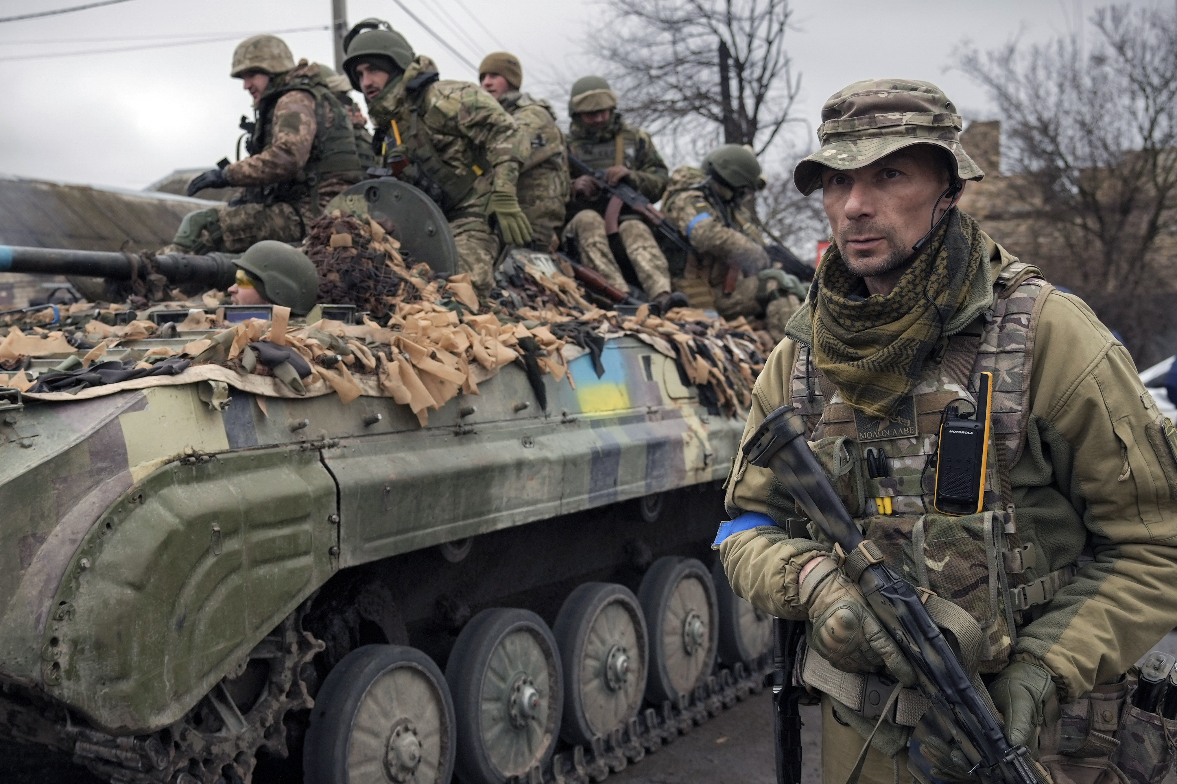 A Ukrainian serviceman walks next to an armoured vehicle outside Kyiv, Ukraine