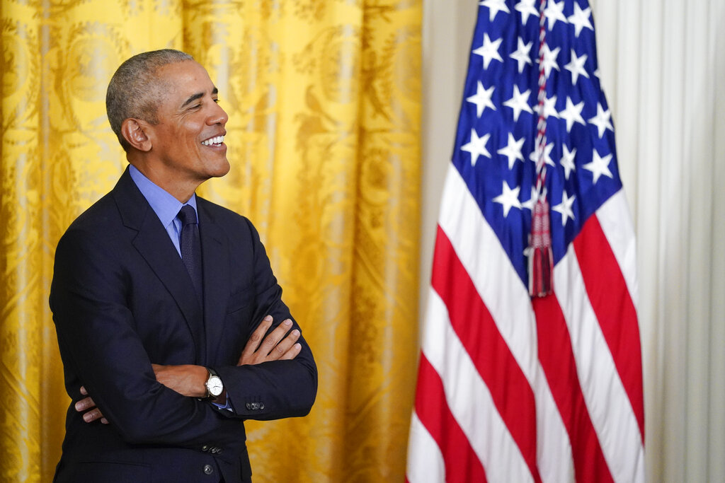 Former President Barack Obama listens as Vice President Kamala Harris speaks about the Affordable Care Act, in the East Room of the White House in Washington.