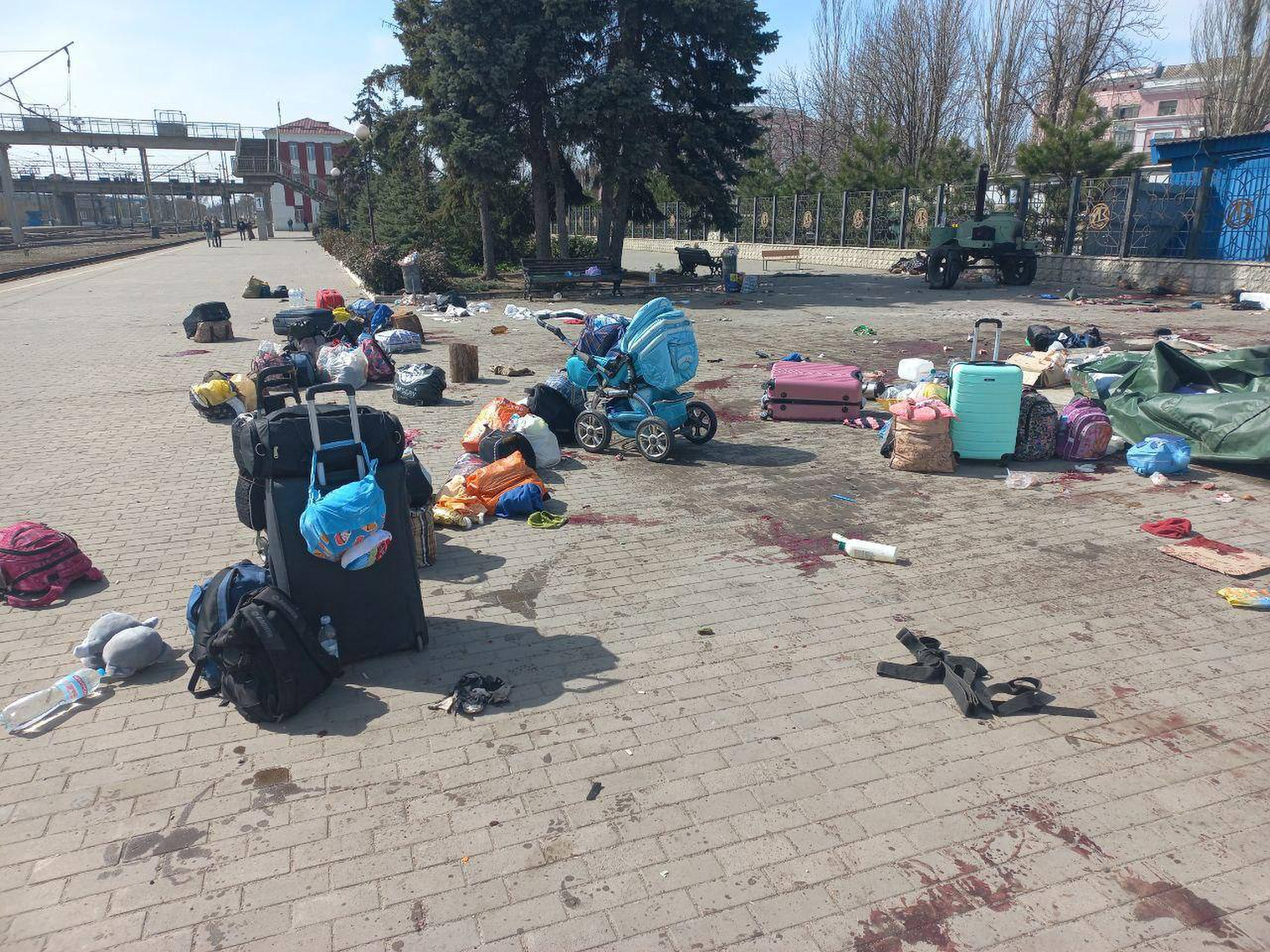 Blood stains are seen among bags and a baby carriage on a platform after Russian shelling at the railway station in Kramatorsk [Volodymyr Zelenskyy’s Telegram channel via AP Photo]