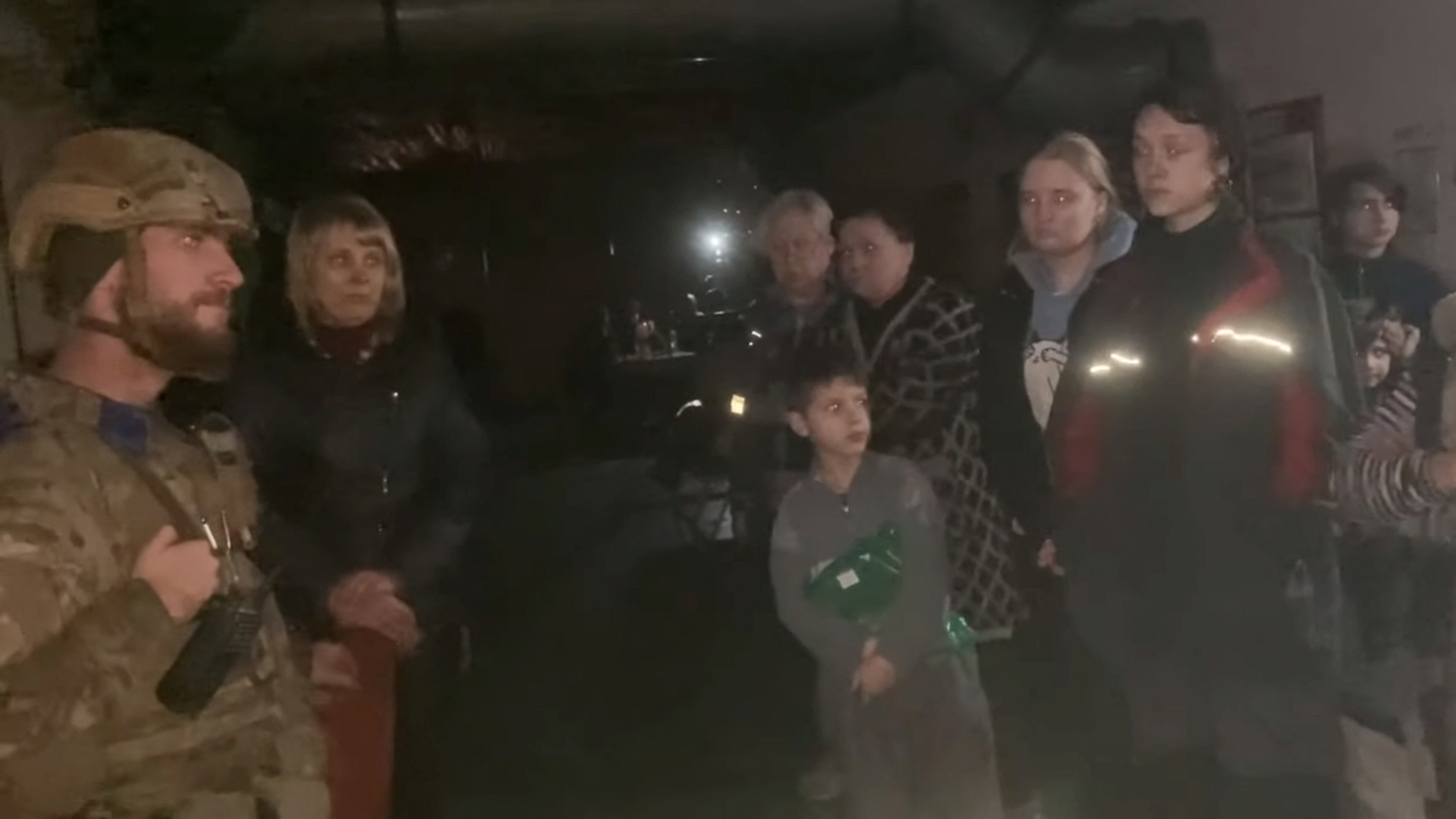 Ukrainian soldier from Azov Battalion and civilians gather on Orthodox Easter Sunday at Azovstal steel plant.
