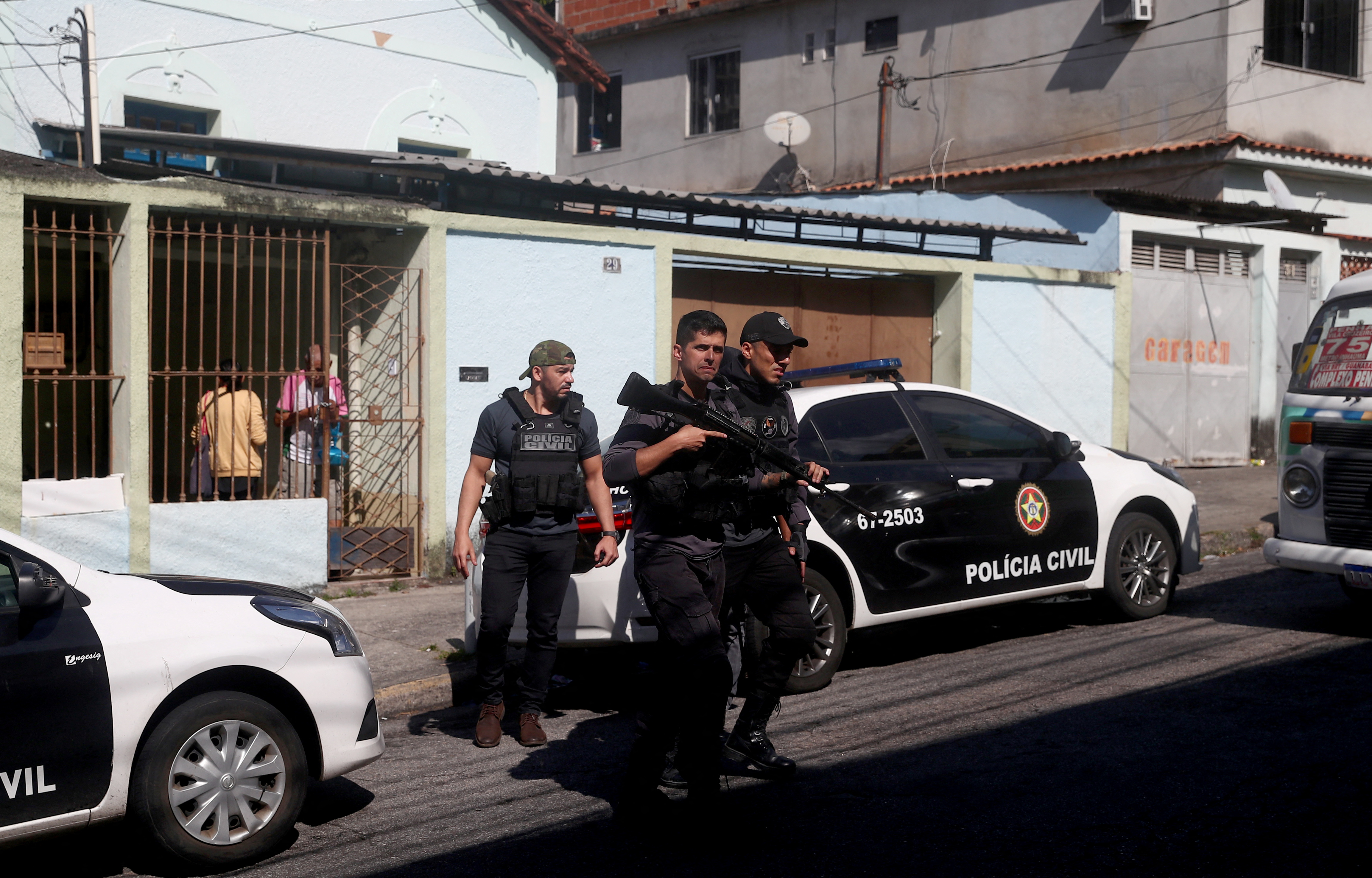 Police officers arrive at the Getulio Vargas Hospital, after more than eleven people were killed during a police operation against drug dealers in the Vila Cruzeiro slum, in Rio de Janeiro, Brazil May 24,