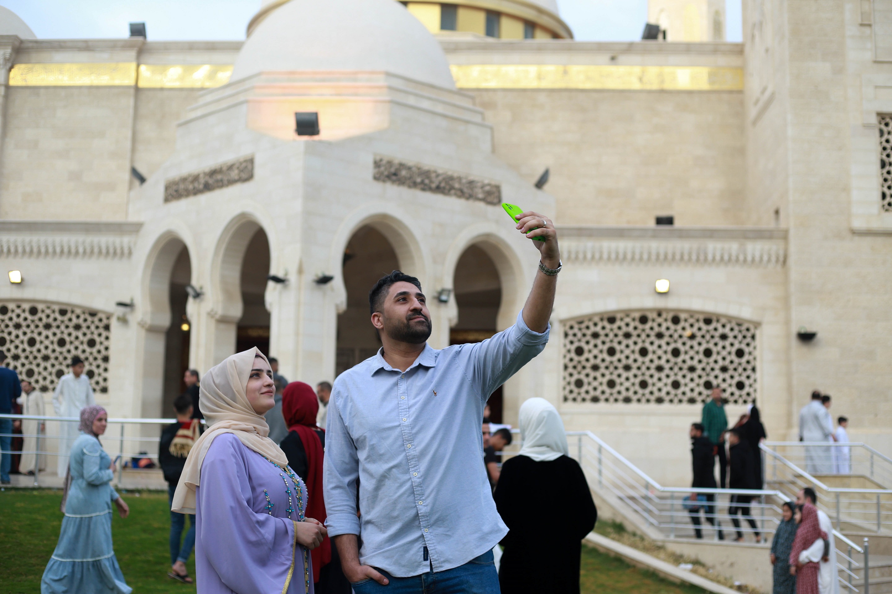 A woman and her husband take photos