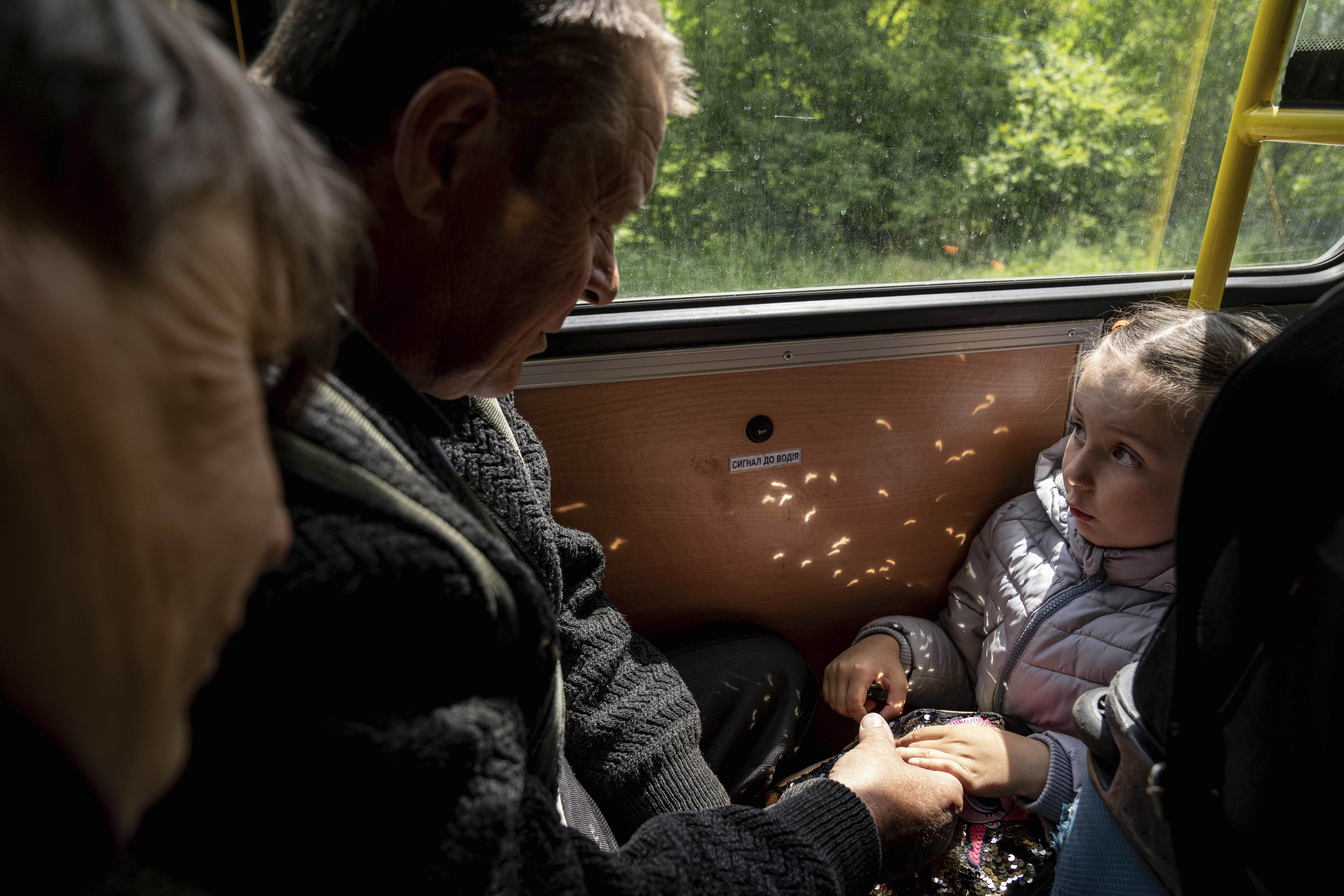 A girl with her grandparents from Lyman, Ukraine in May