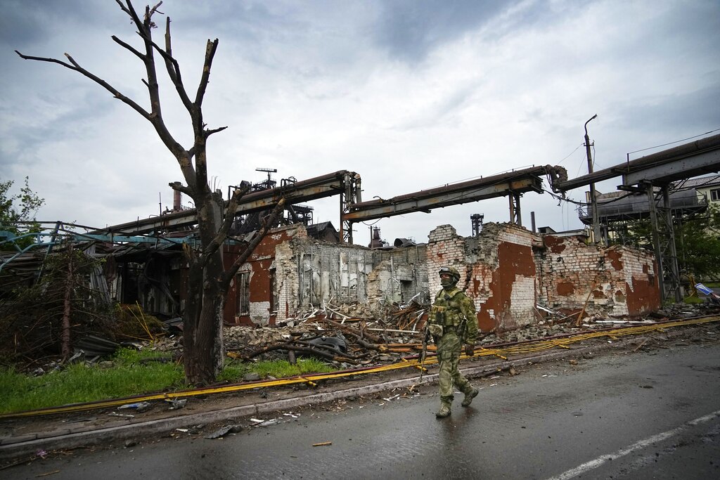 A Russian soldier patrols a destroyed part of the steel mill in Mariupol in the Donbas region, May 18 [AP Photo]