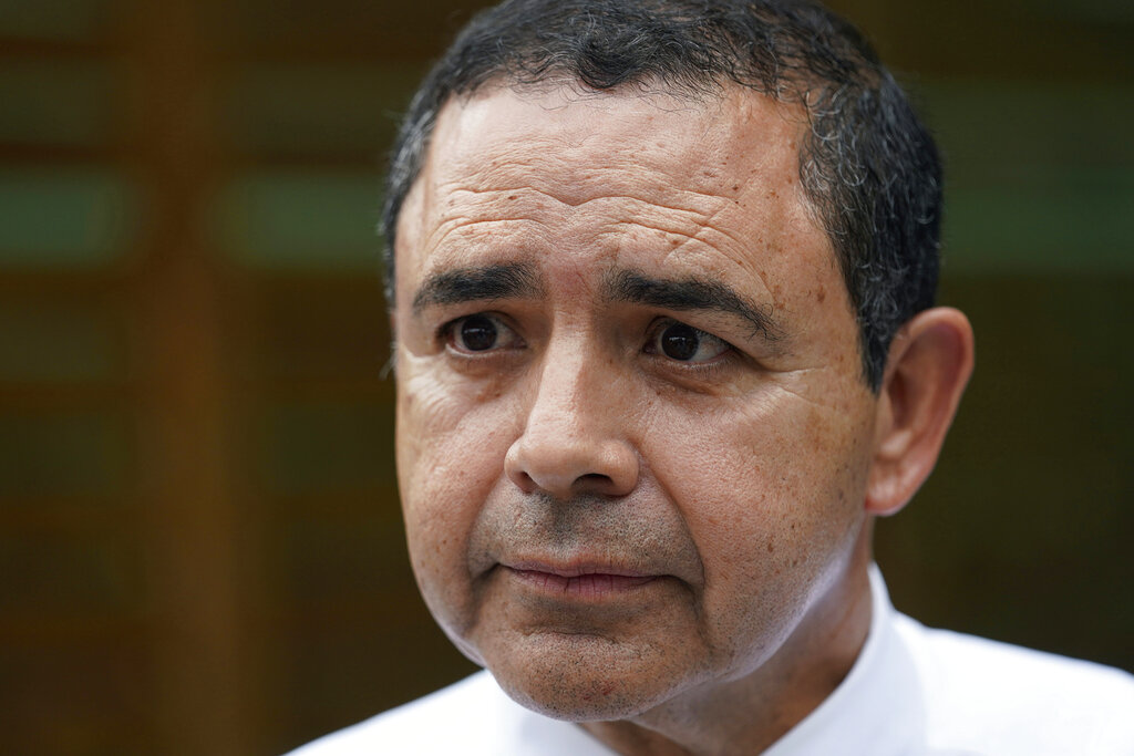 .S. Rep. Henry Cuellar, D-Laredo, talks to a member of the media during a campaign event. Cuellar, a 17-year incumbent is facing a Democratic primary runoff against progressive Jessica Cisneros. 