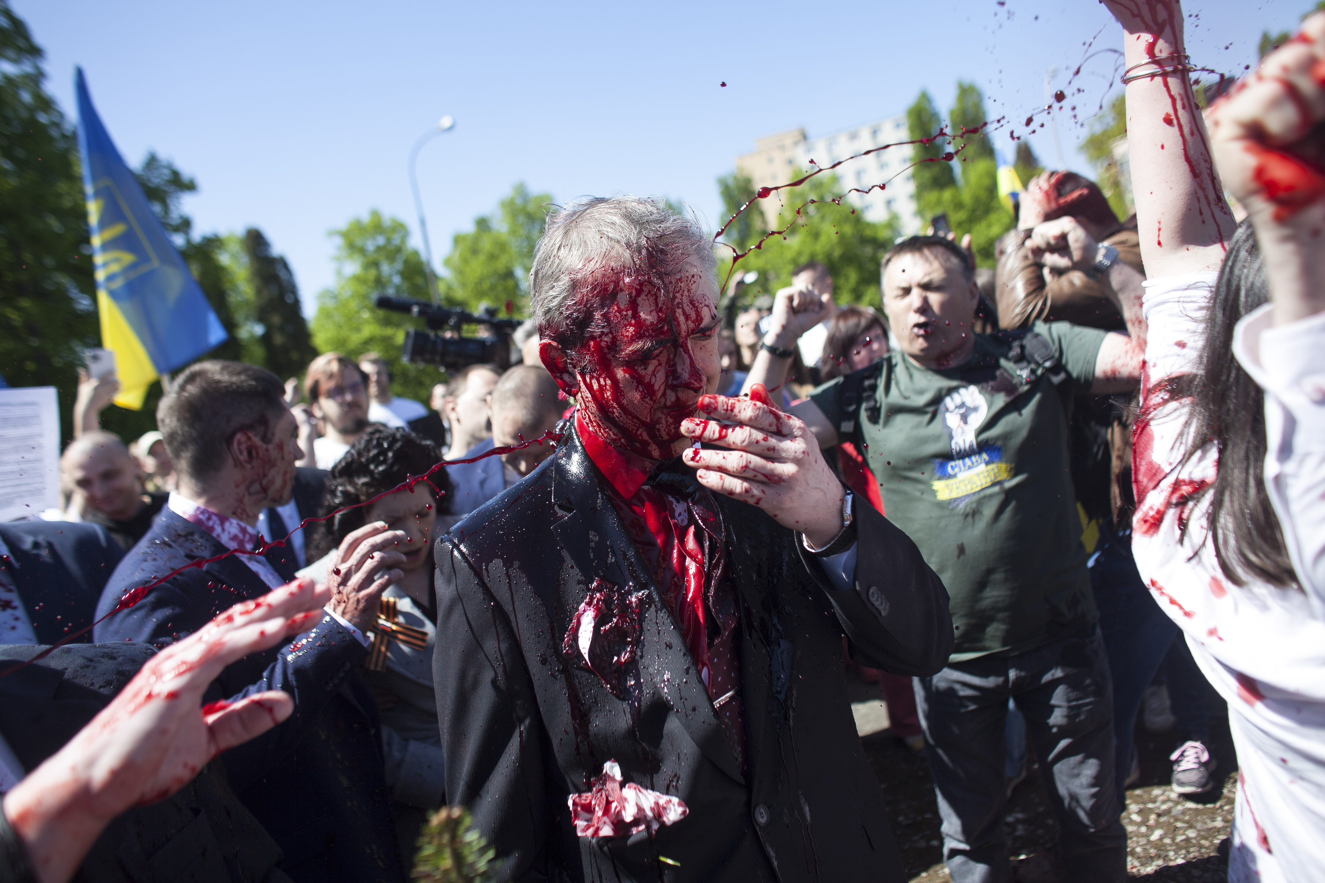 Russian ambassador to Poland, Sergey Andreev, is covered with red paint in Warsaw, on Monday, May 9, 2022