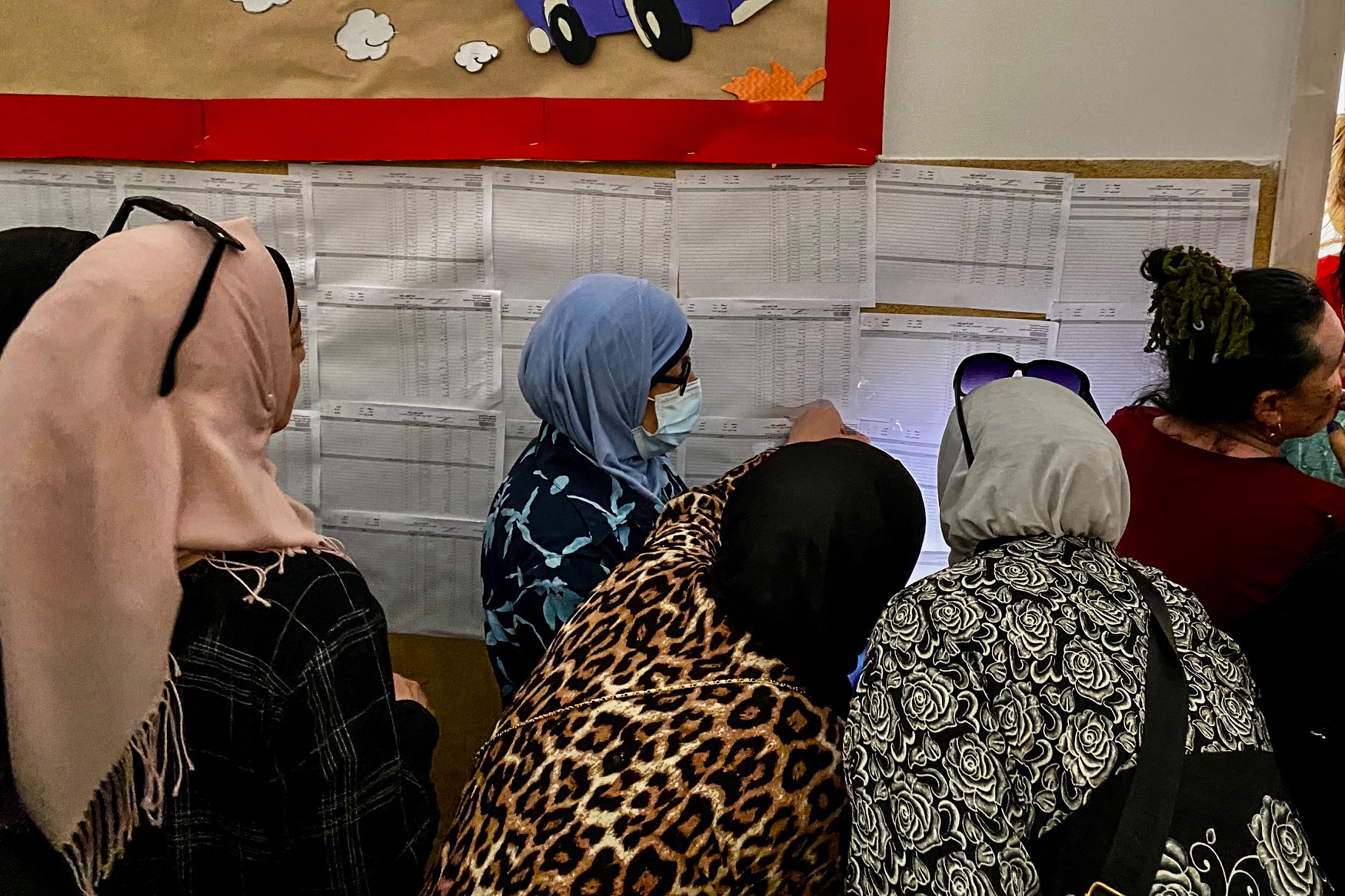 Voters and staff at a polling station in a Beirut school rely on phone flashlights and battery-powered lamps because of power cuts