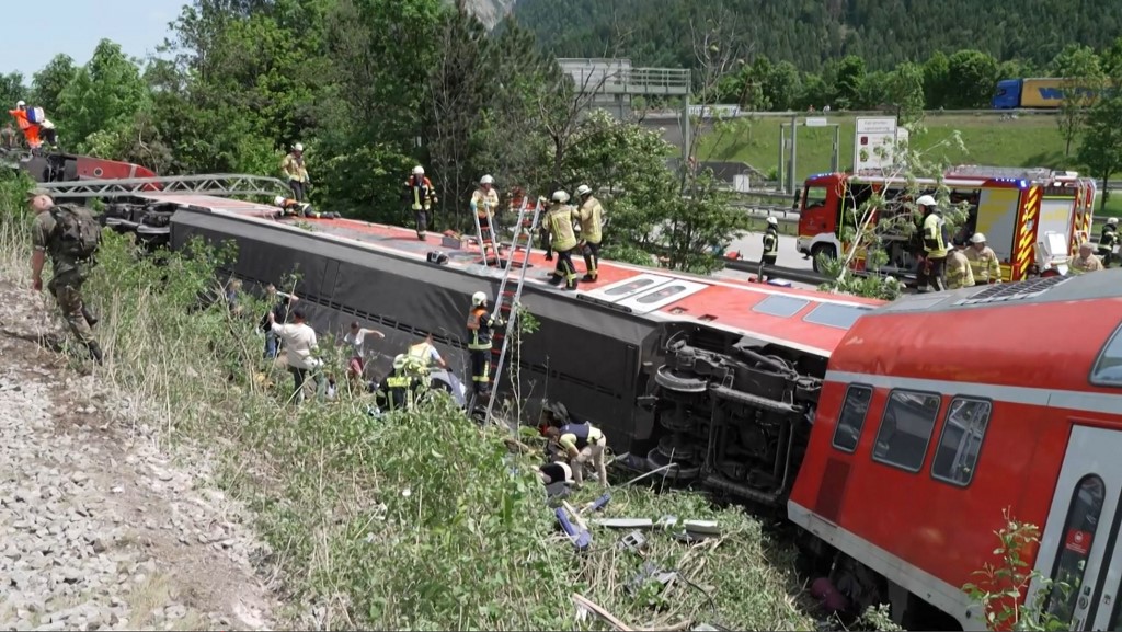 rescue services at the site of a derailed train near Burgrain, southern Germany