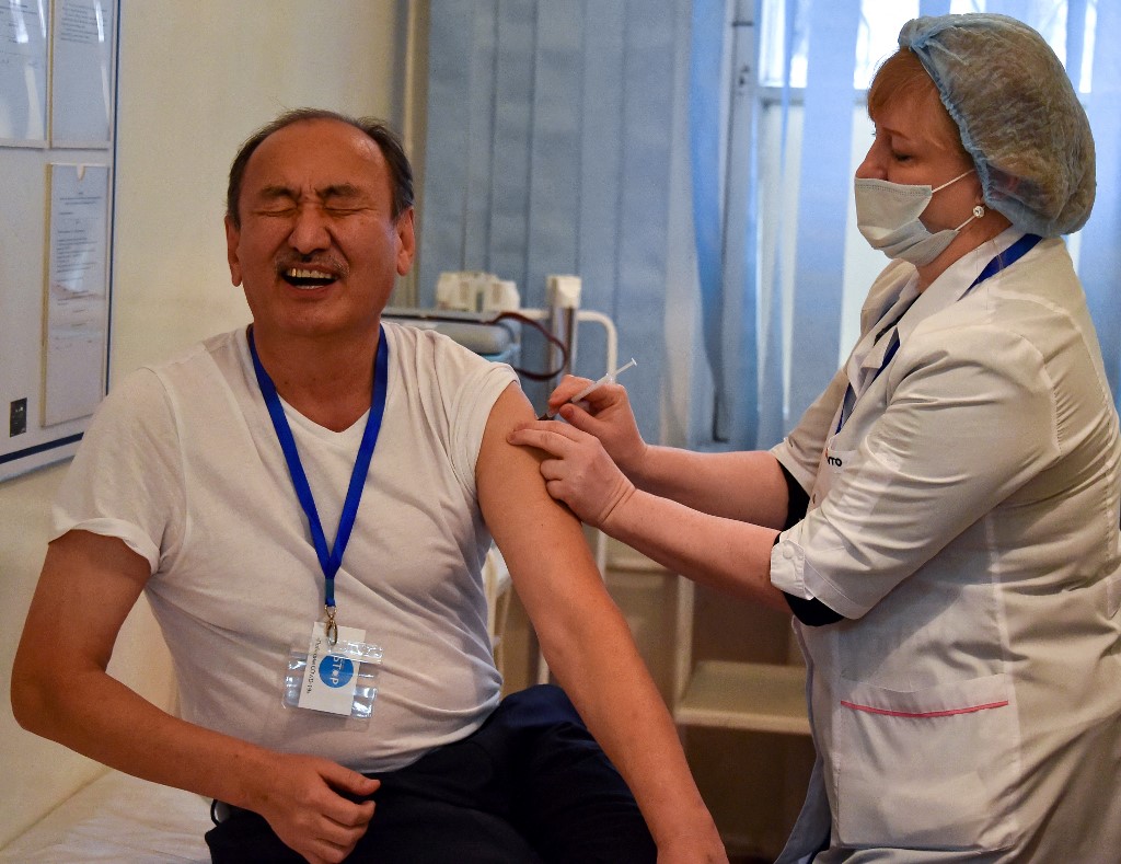 Kyrgyz Health Minister Alymkadyr Beishenaliyev receives a dose of the Sinopharm vaccine