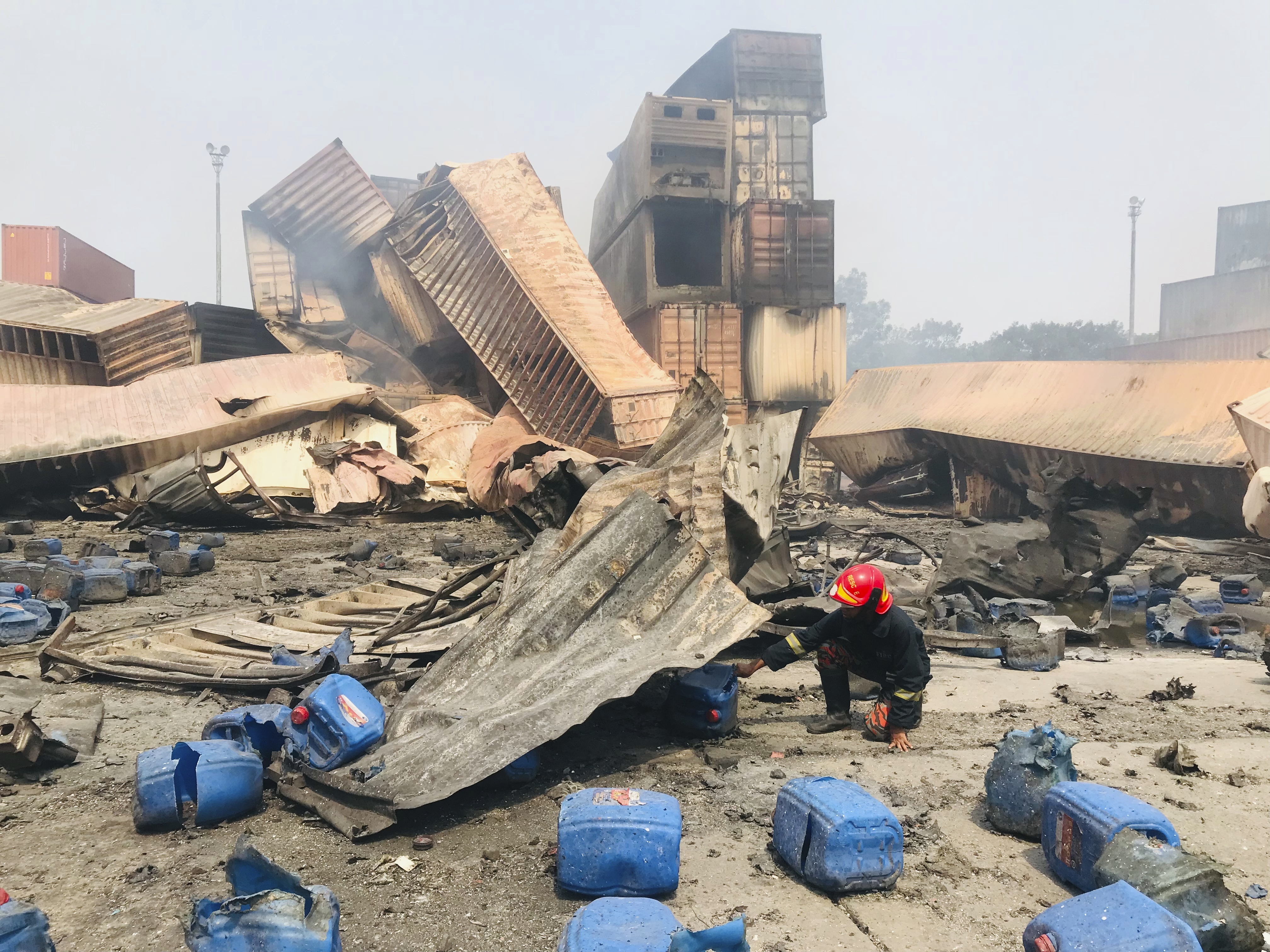 A member of the rescue team inspects wreckage at the BM Inland Container Depot at Sitakunda