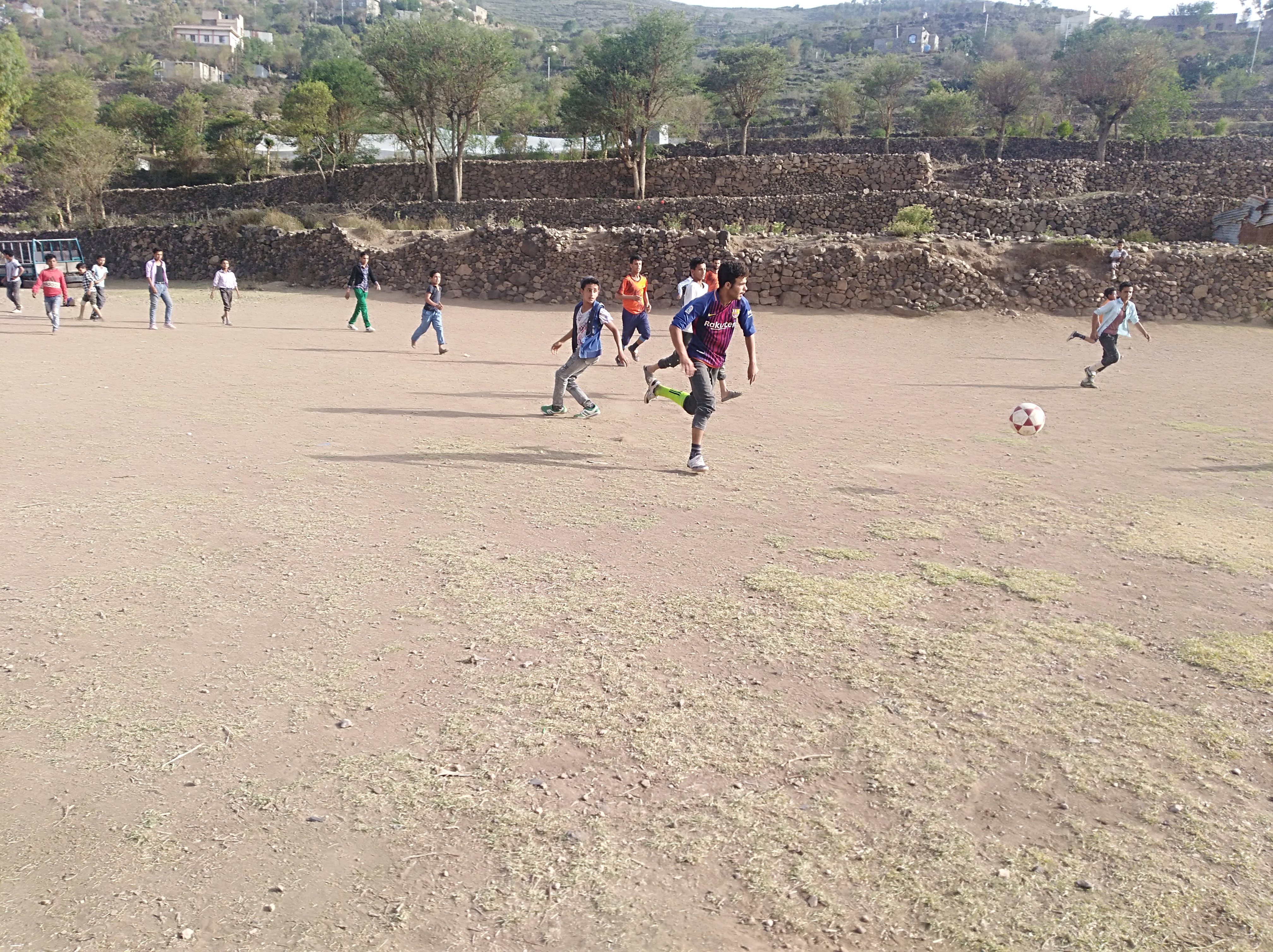 A game of football taking place across the sandy pitch in Ibb [Abdullah Ali]