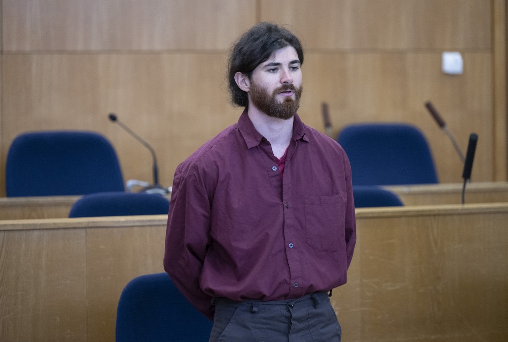 Defendant Franco A, a 33-year-old German army officer, accused of posing under a false identity as an asylum seeker in 2017 and planning an attack that he seemingly hoped would be blamed on migrants, reacts upon arrival for his trial at a Regional Court in Frankfurt am Main
