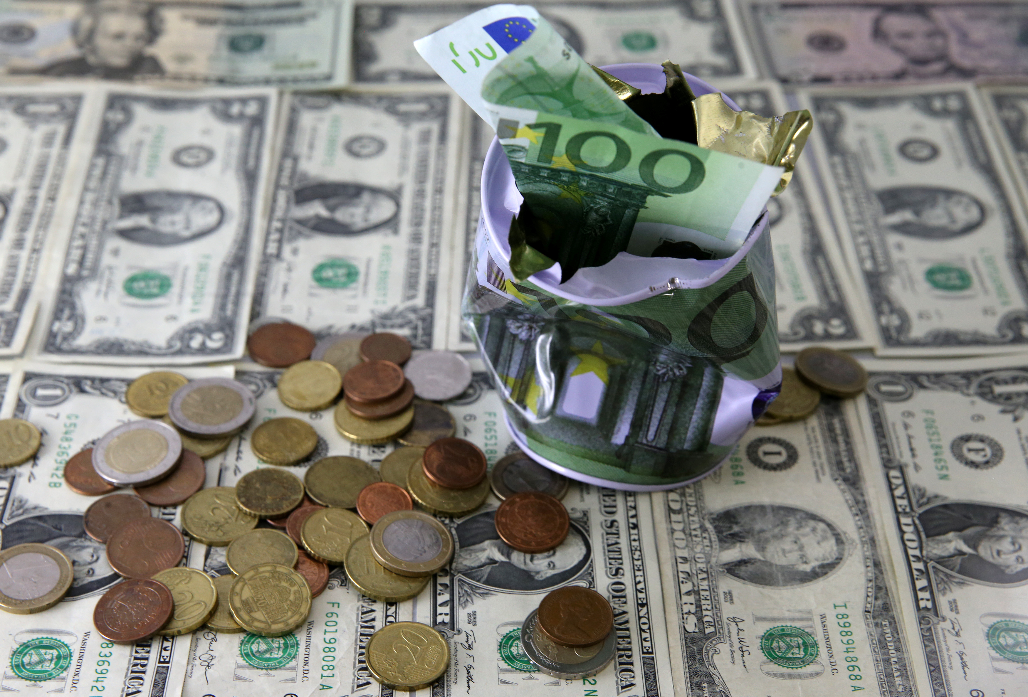 Dollar banknotes and Euro banknote and coins