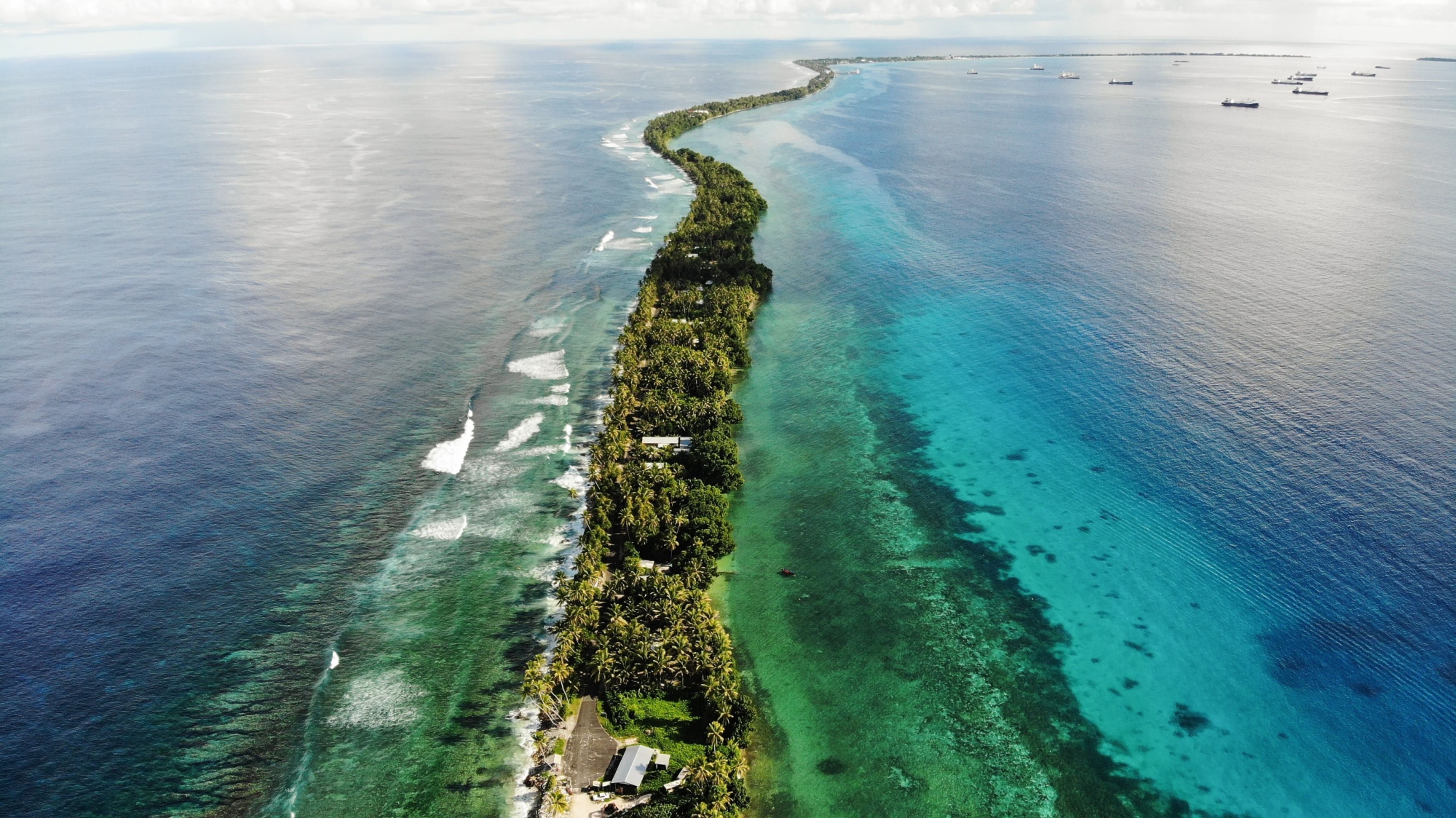 A strip of land between the Pacific Ocean and a lagoon in Funafuti, Tuvalu.