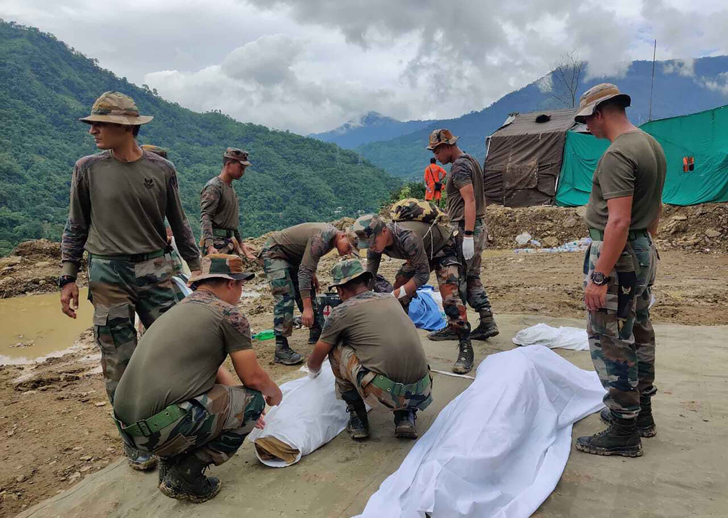 Soldiers wrap bodies of victims of a mudslide in Noney, Manipur state, India