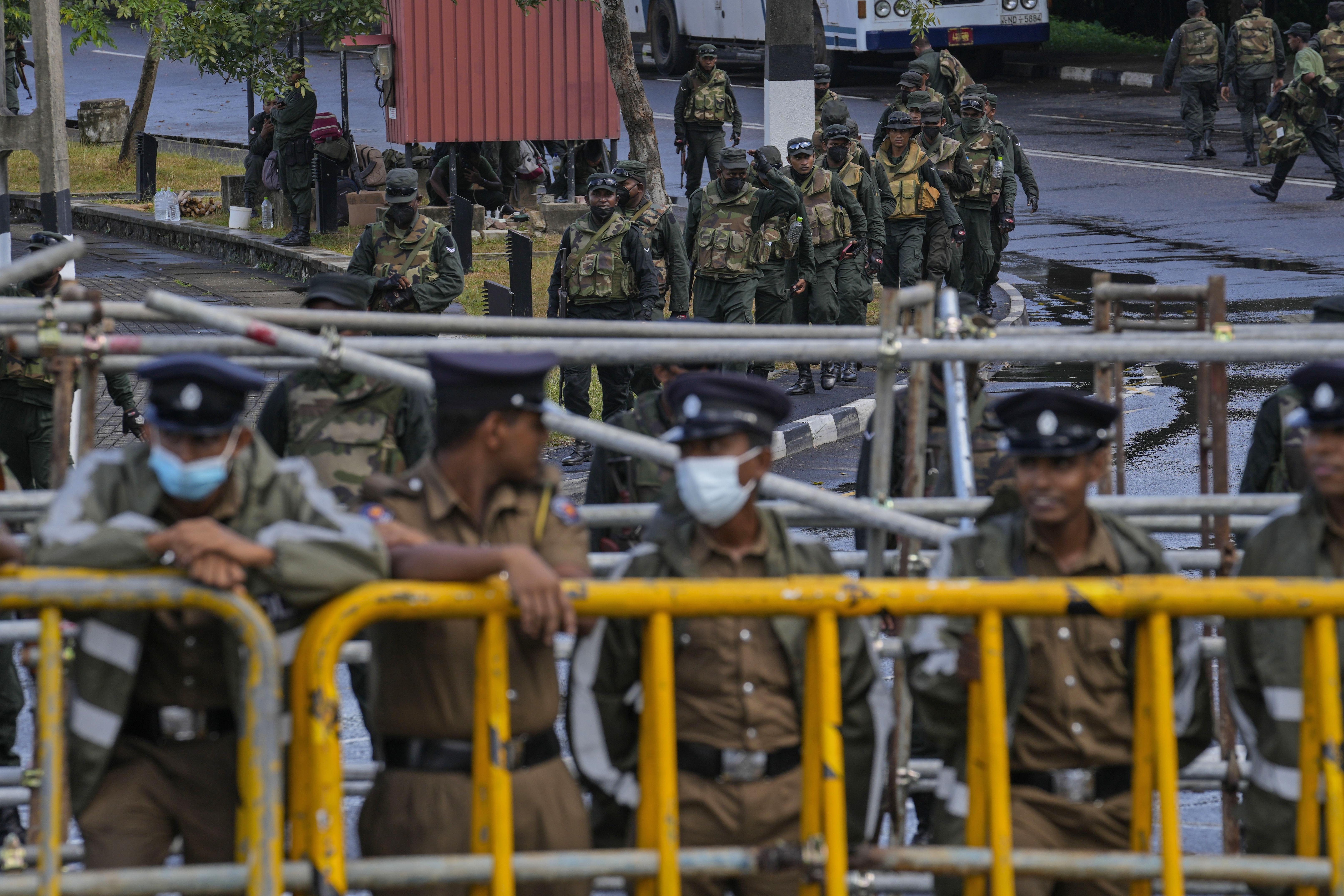 Army soldiers patrol outside the parliament complex in Colombo