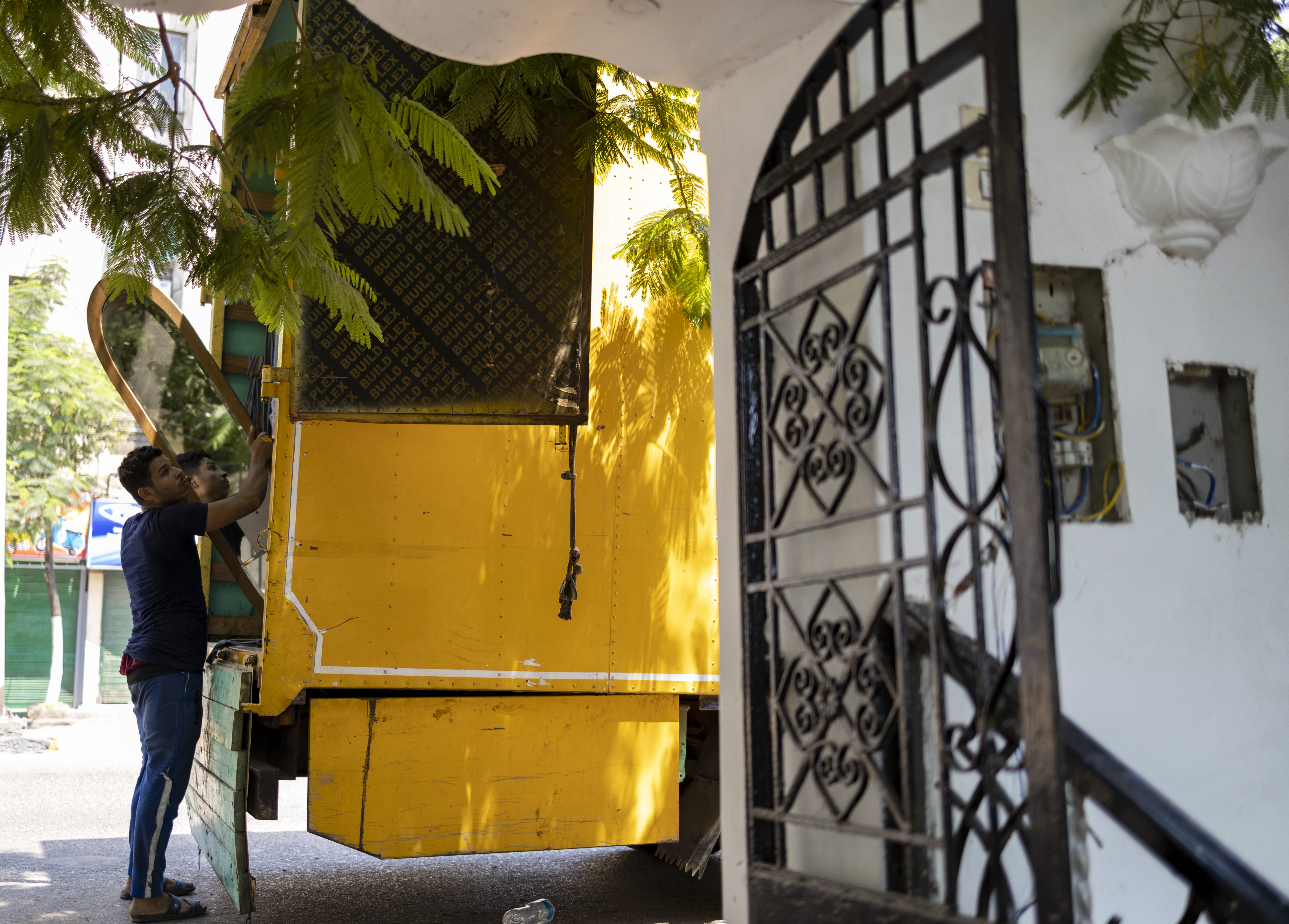 Movers take away some of the belongings of owners who are getting ready to leave behind the only place they’ve called home. Image captured by Toka Omar.