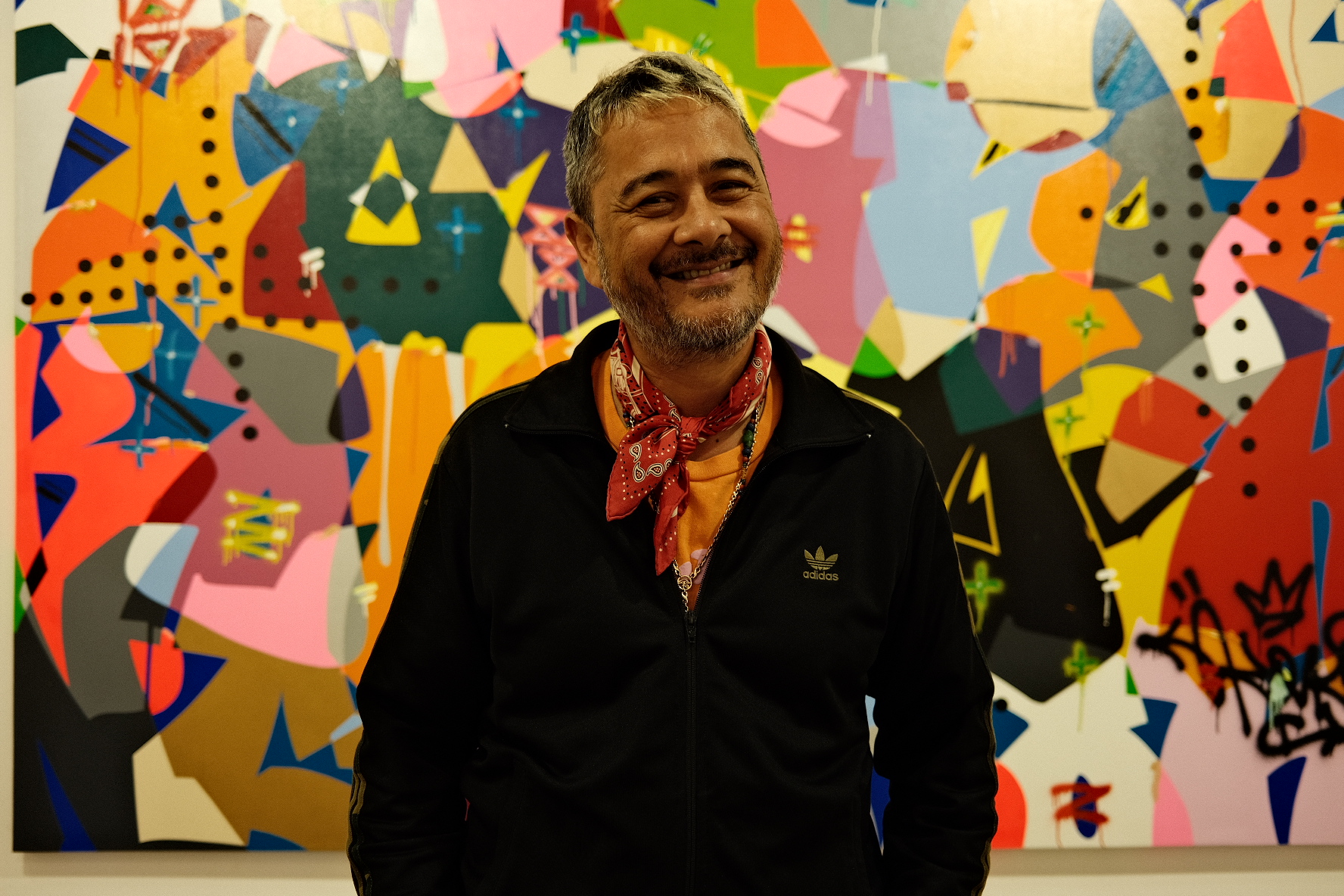 Cyril Kongo in front of one of his graffiti-style paintings at Art Jakarta.