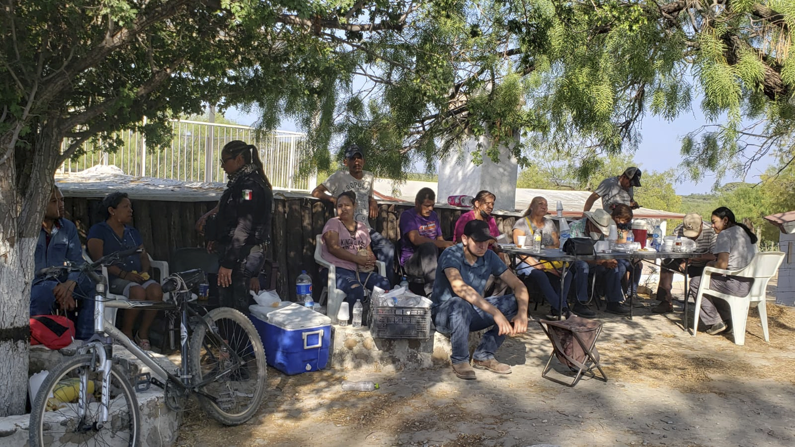 Relatives of miners who were trapped in the flooded coal mine in Sabinas wait for information outside the mine