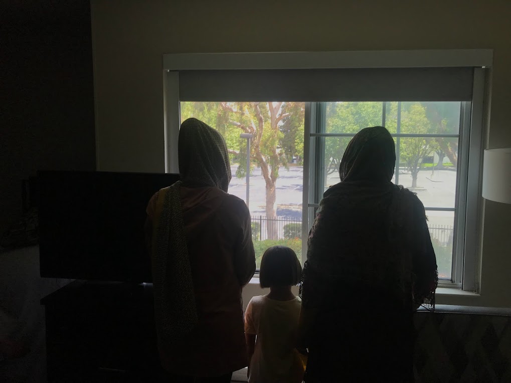 Zarghon stands with some members of her family in a motel in San Jose, California in August. Afghans who resettled in the US after the US withdrawal have struggled with myriad obstacles