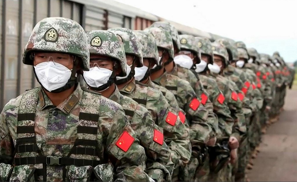 This screen grab obtained from a handout video released by the Russian Defence Ministry on August 29, 2022, shows Chinese soldiers marching along a railway platform upon their arrival for 'Vostok-2022' military exercises at the Sergeevsky training ground at Primorskiy (Maritime) Kray of the Russian Far East