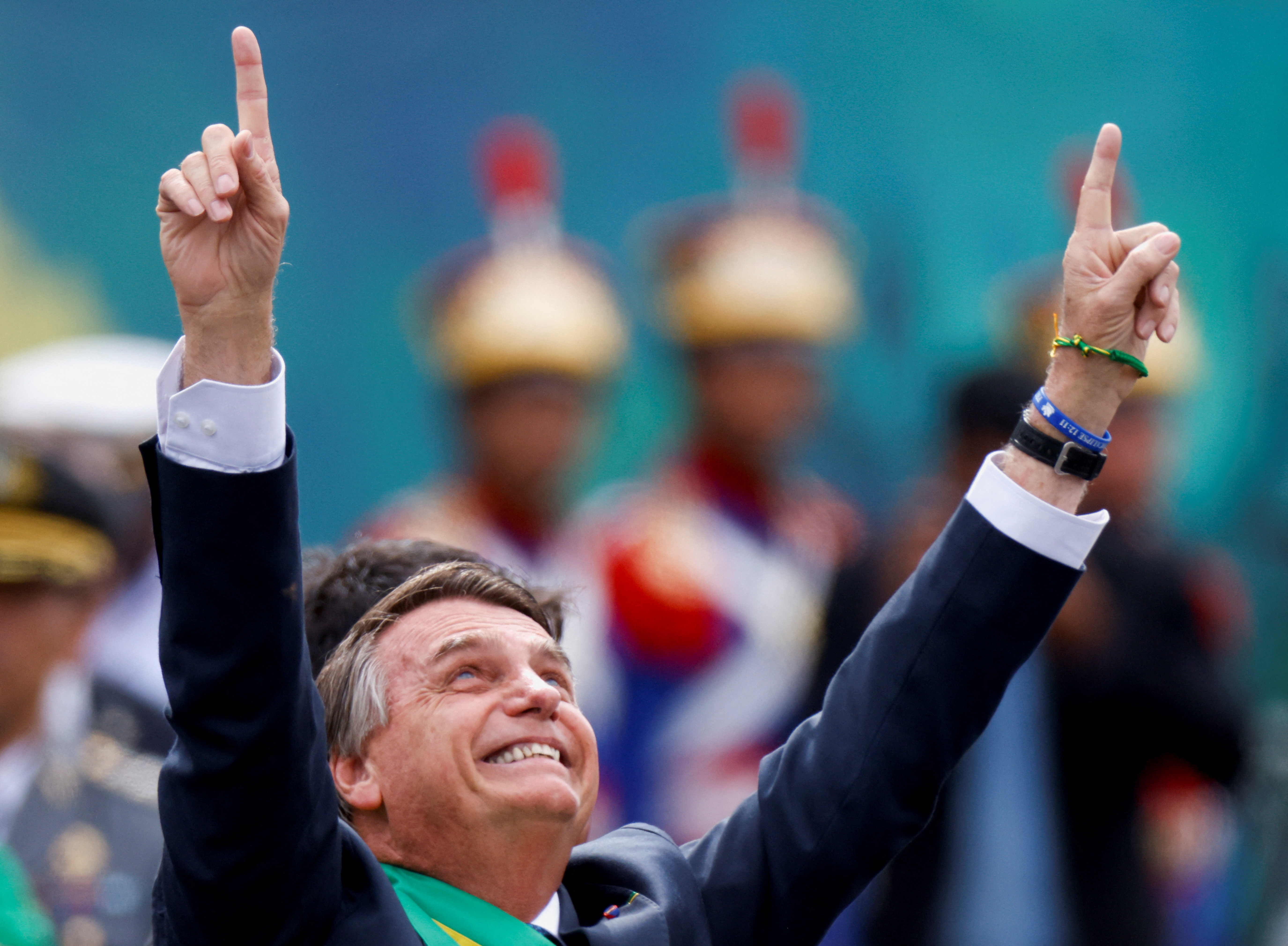 Brazil's President Jair Bolsonaro points to the sky during a rally in Brasilia