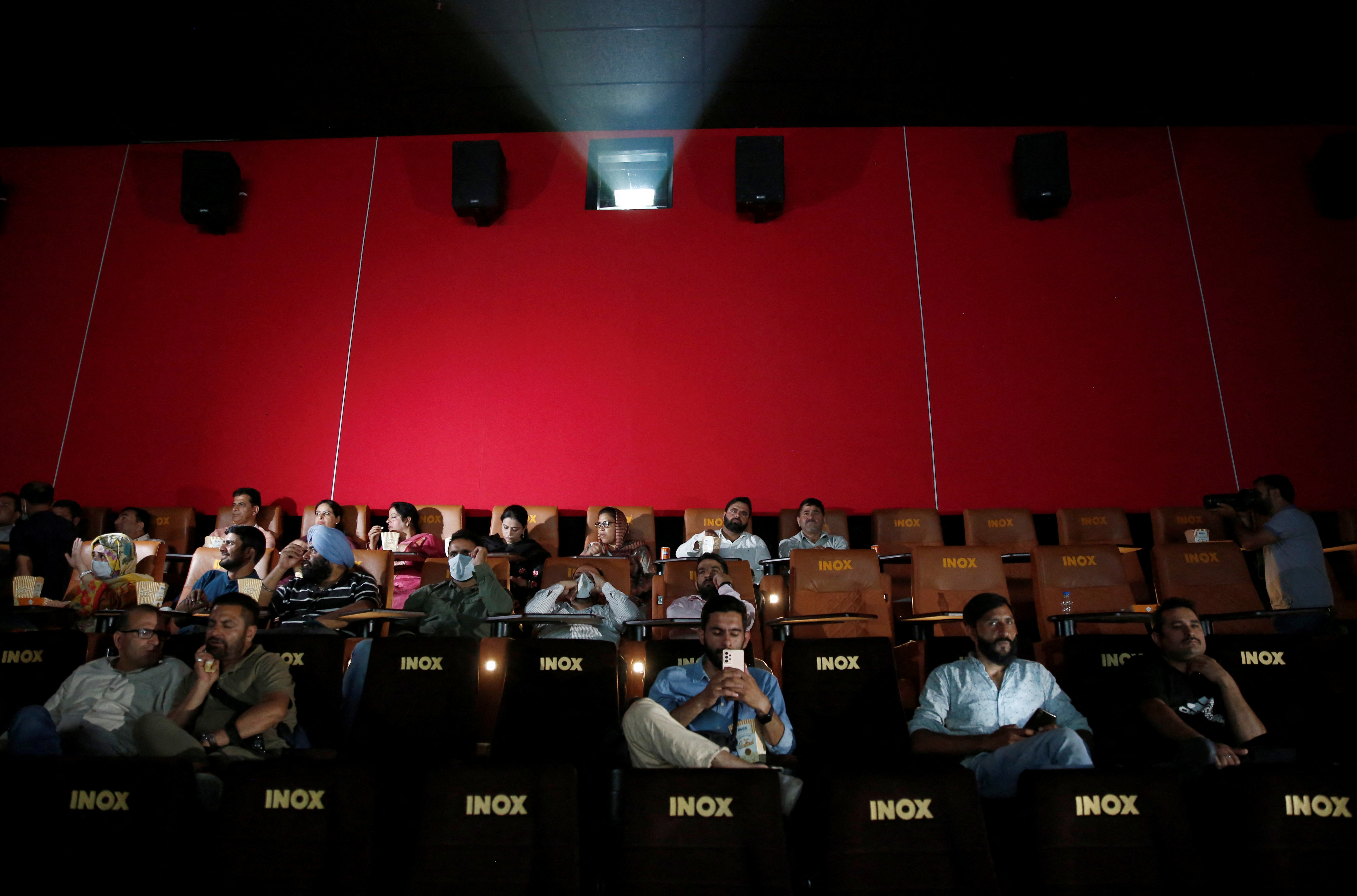 Journalists and government officials at the cinema after it opened in Srinagar
