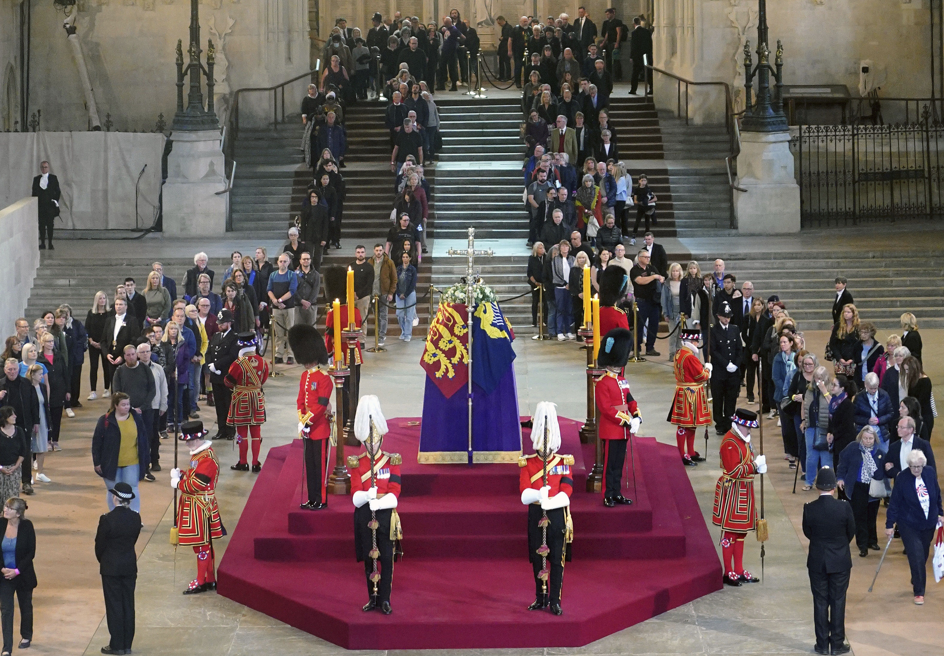 Members of the public pay their respects as they walk past the coffin of Queen Elizabeth II lying in state on the catafalque in Westminster Hall
