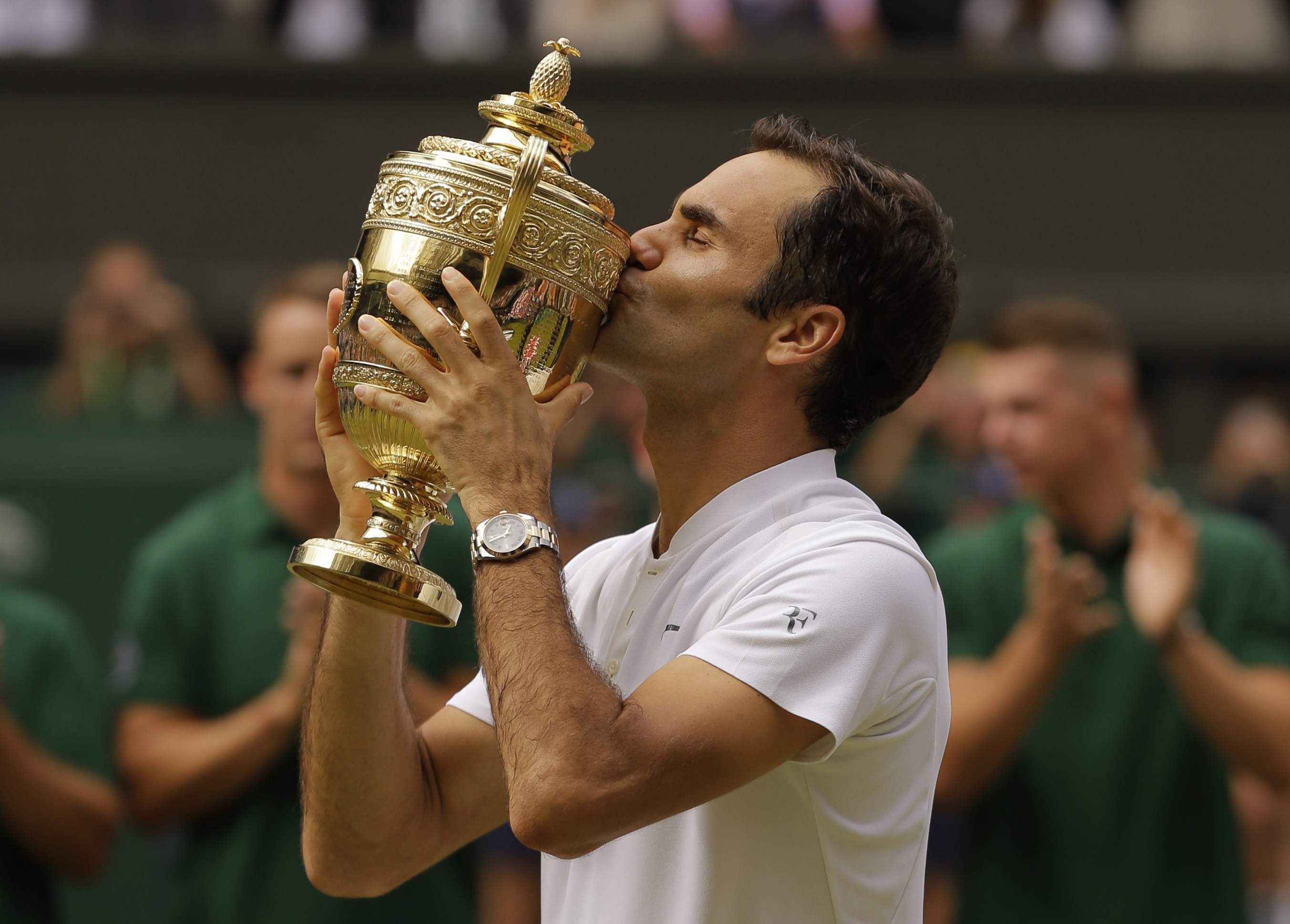 Switzerland’s Roger Federer kisses the trophy after defeating Croatia’s Marin Cilic to win the Men’s Singles final match at the 2017 Wimbledon Tennis Championships