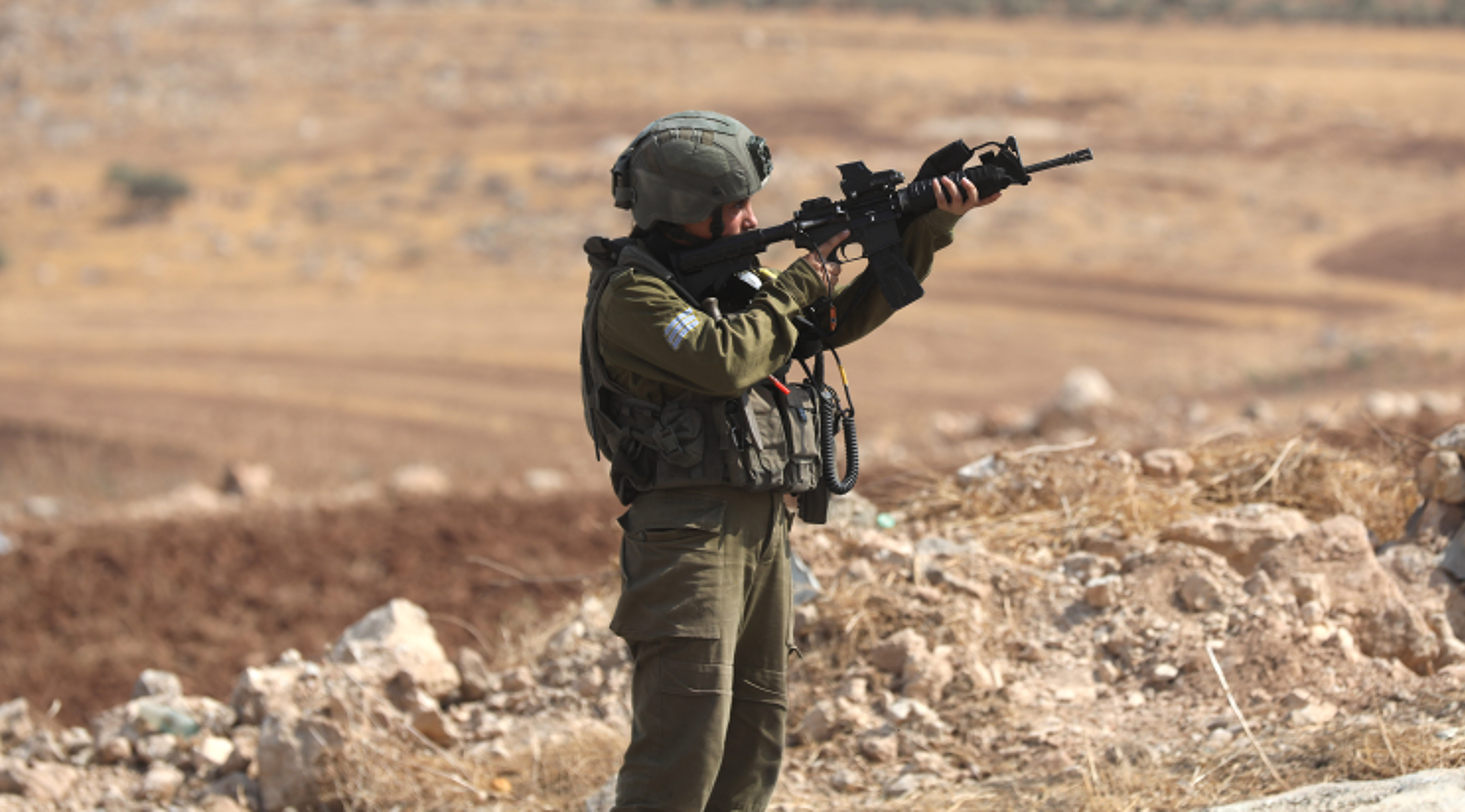 Israeli soldier pointing gun