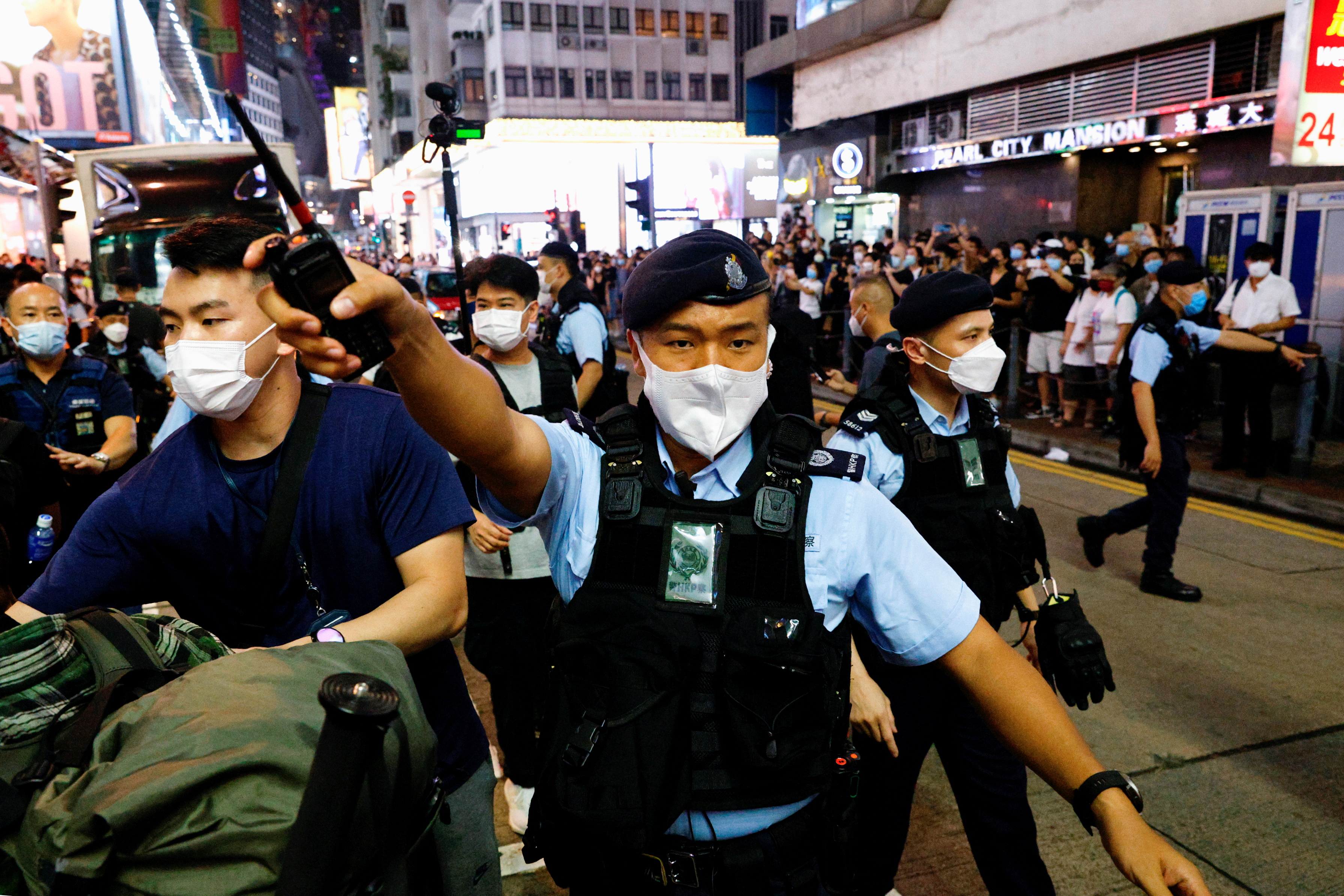 Police officers ask people to leave outside Hong Kong's closed Victoria Park on the 33rd anniversary of the crackdown on pro-democracy demonstrations at Beijing's Tiananmen Square in 1989.