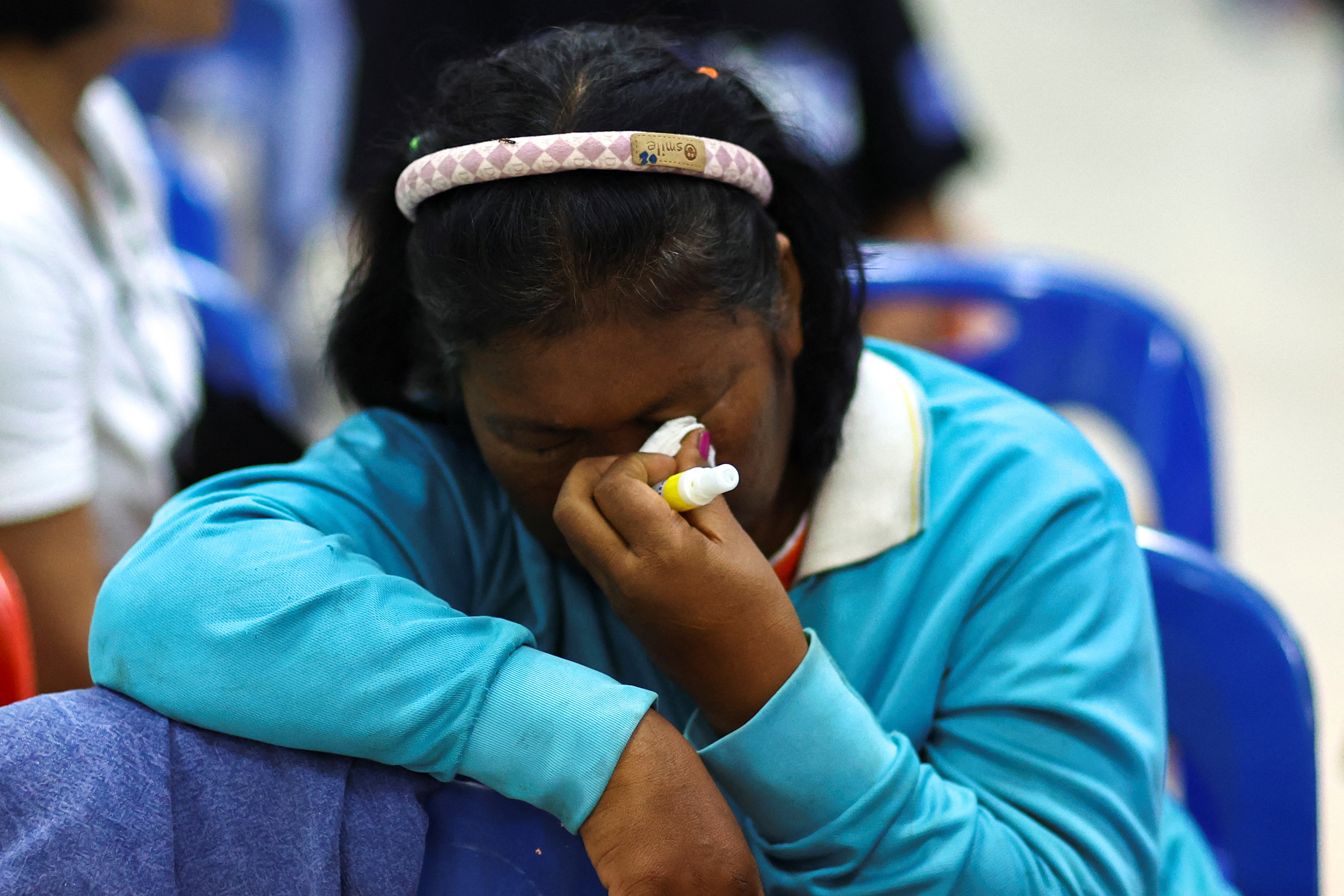A woman reacts as people gather outside a day care center which was the scene of a mass shooting, in the town of Uthai Sawan, around 500 km northeast of Bangkok in the province of Nong Bua Lam Phu, Thailand October 6, 2022. REUTERS/Athit Perawongmetha