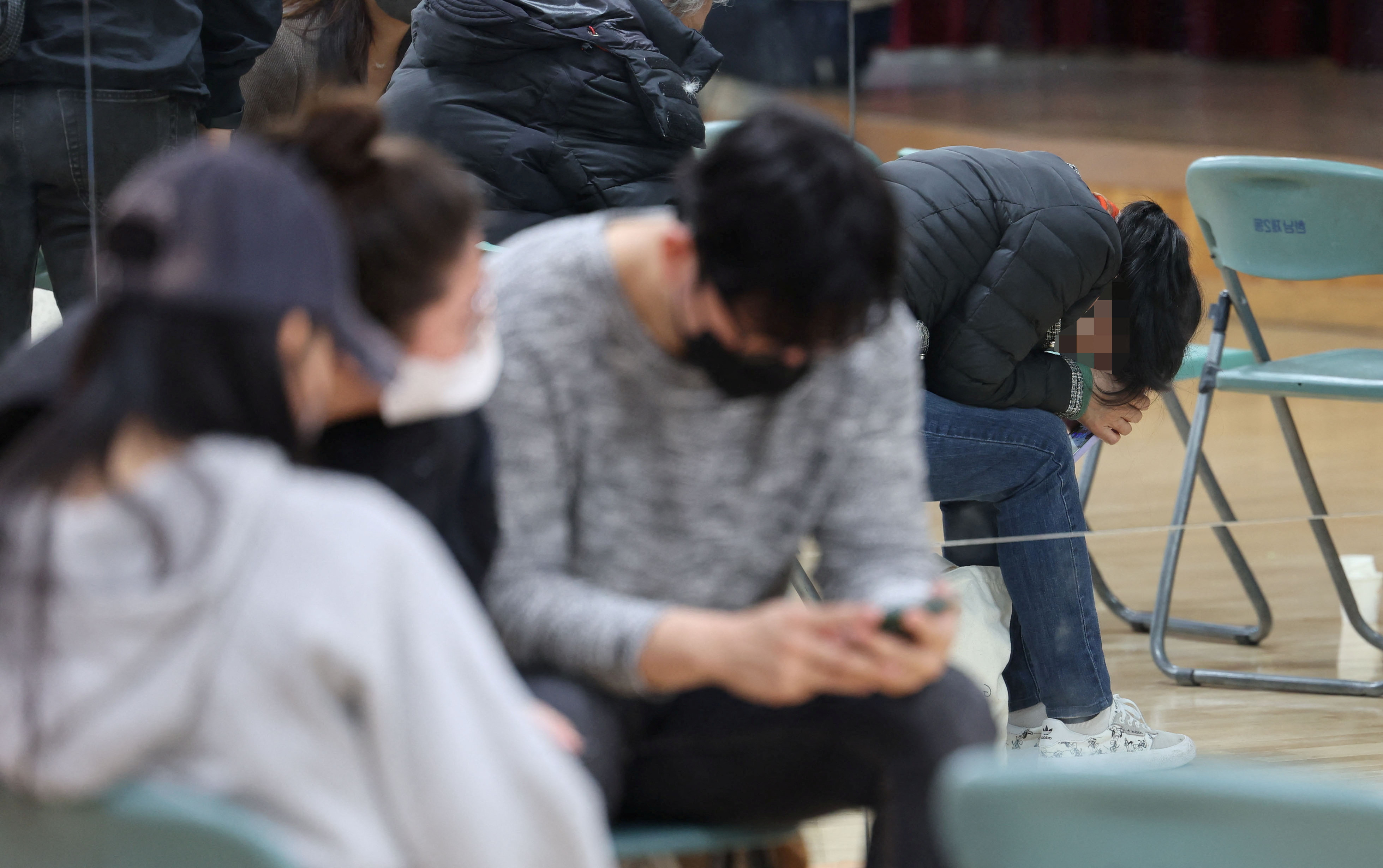 Family members of people missing after a stampede during Halloween festivities, gather at a community service center in Seoul, South Korea, October 30, 2022.