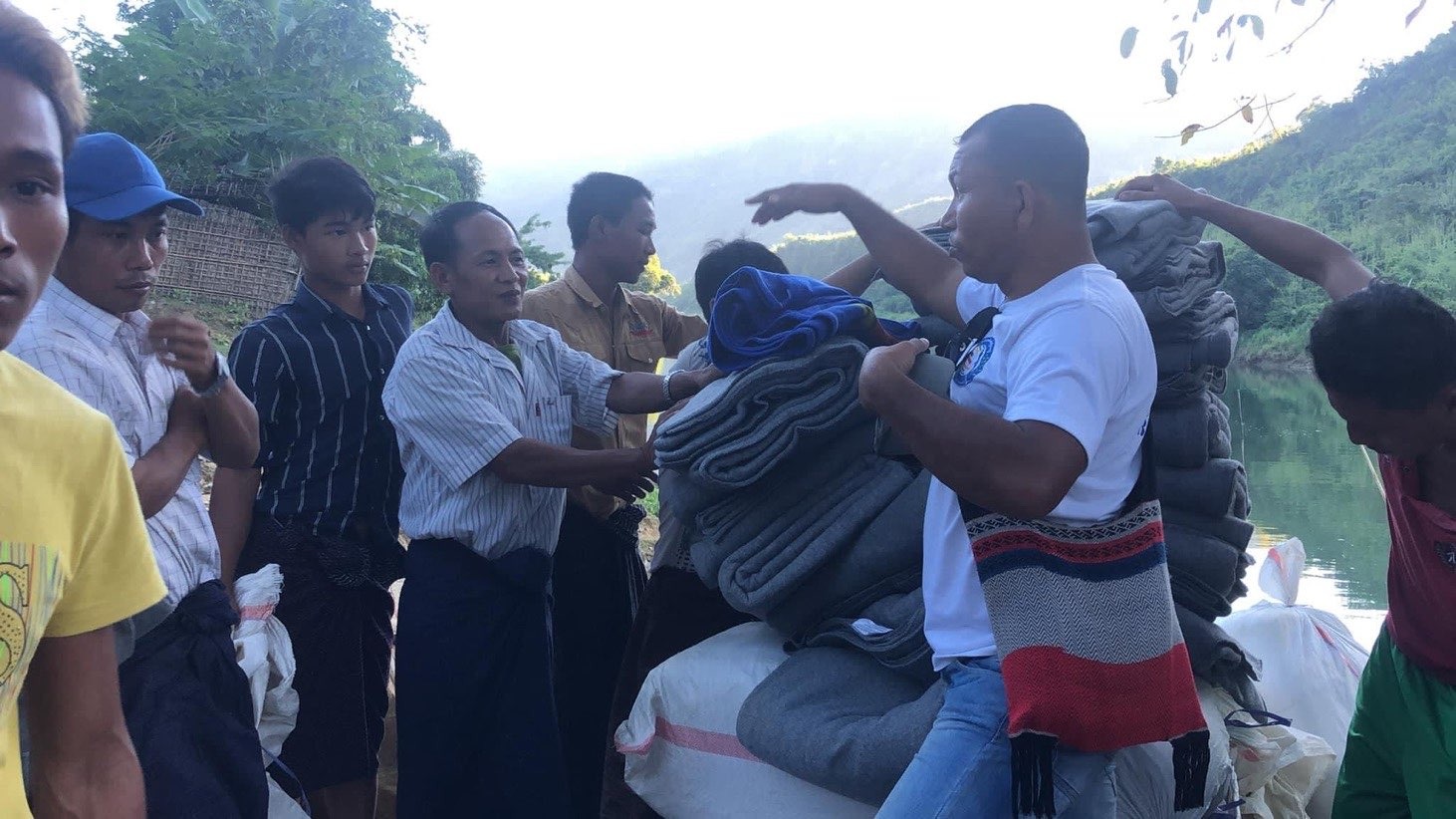 Ann Thar Gyi distributes blankets to villagers in Myanmar.
