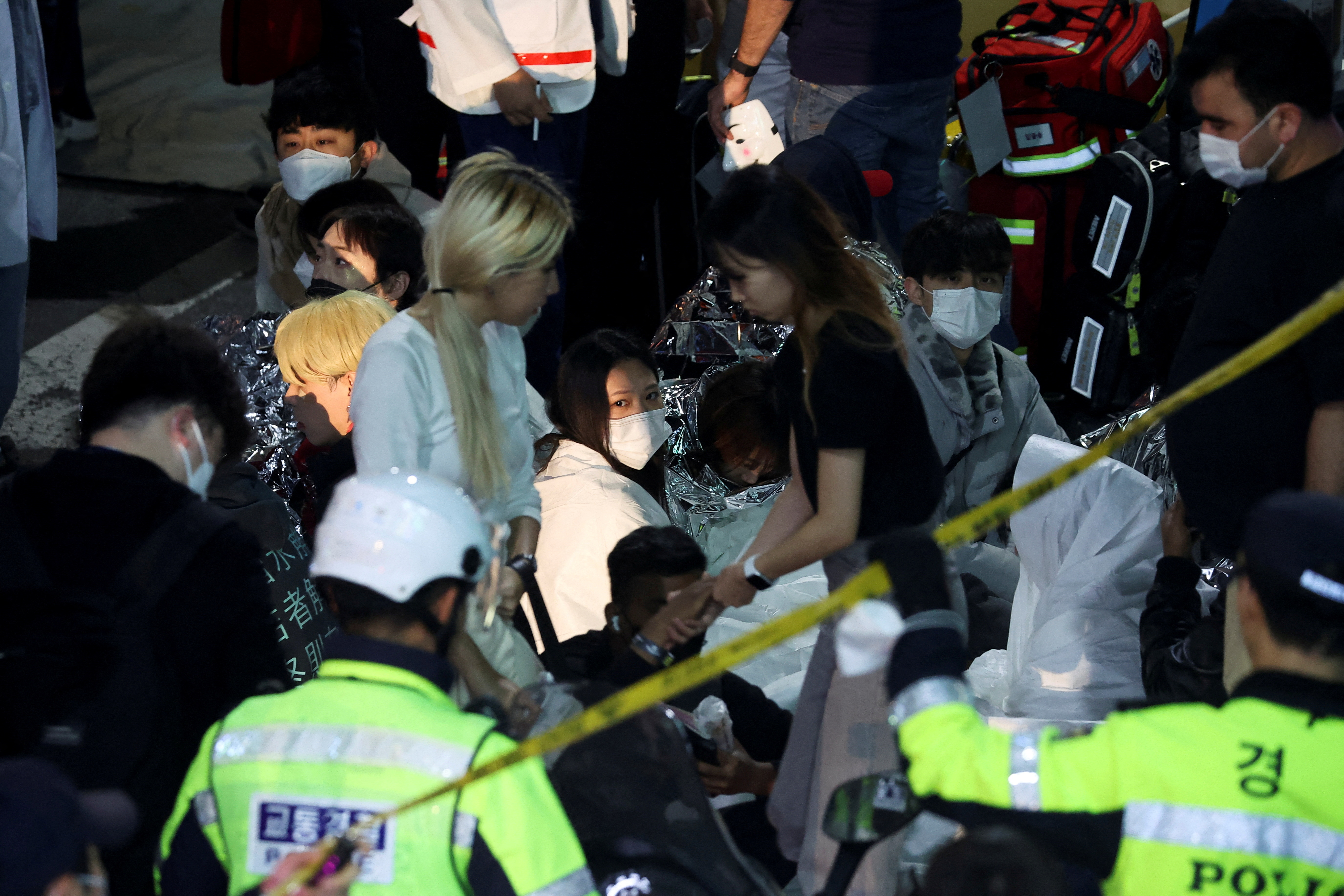 Rescue teams work at the scene of the stampede on Saturday