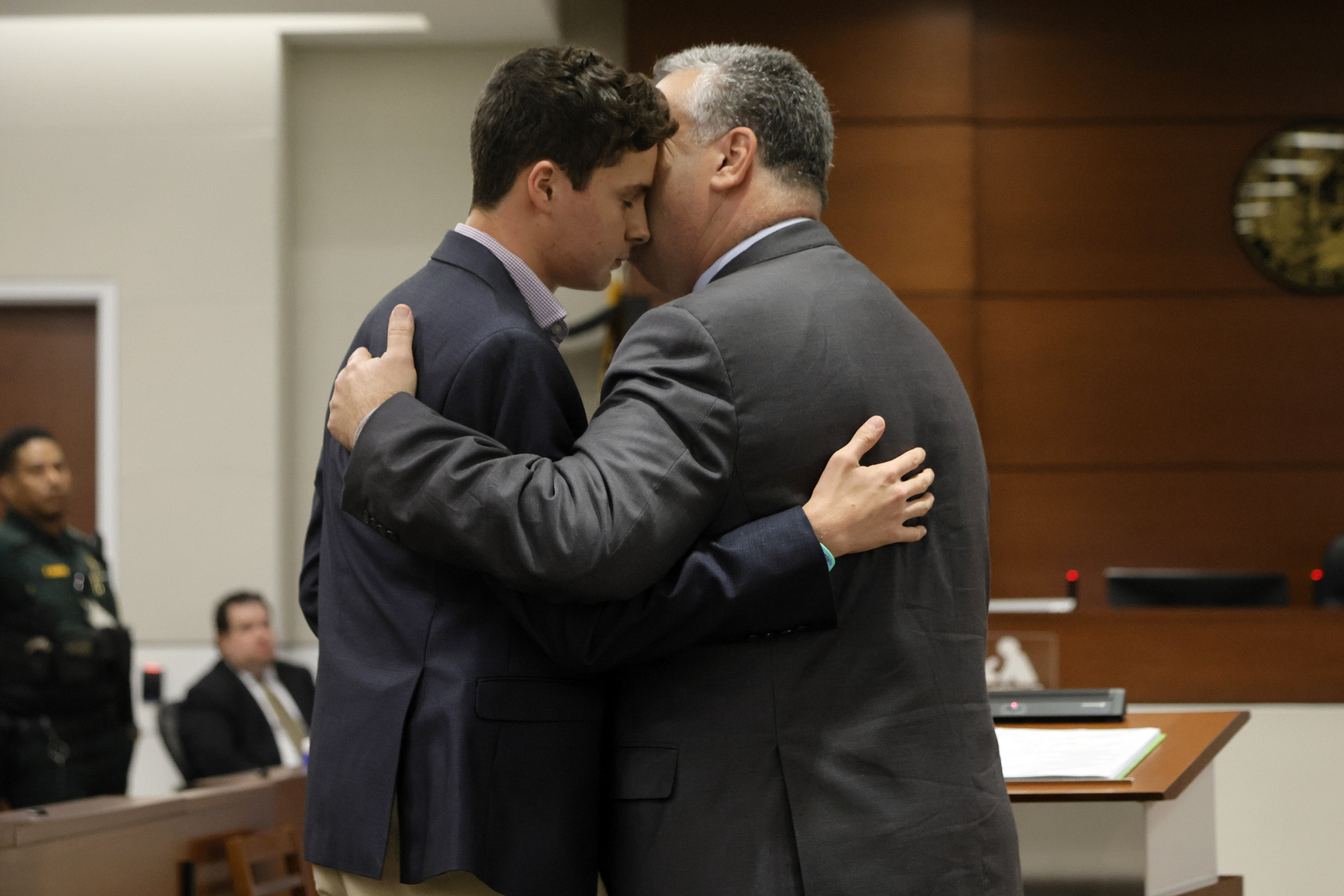 Tony Montalto embraces his son, Anthony, after giving victim statements ahead of the sentencing of Nikolas Cruz