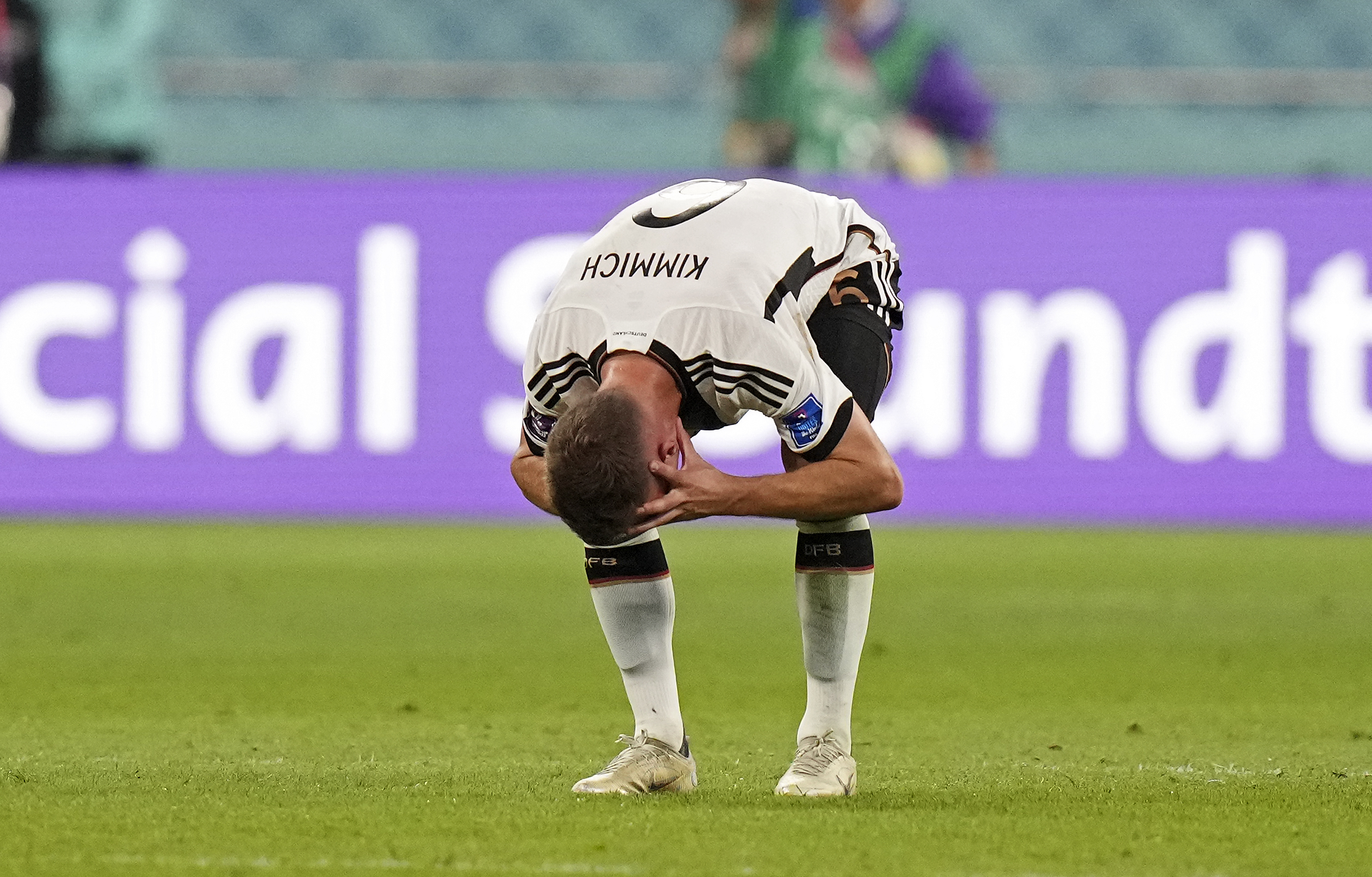 Kimmich bowing down low with his head in his hands 